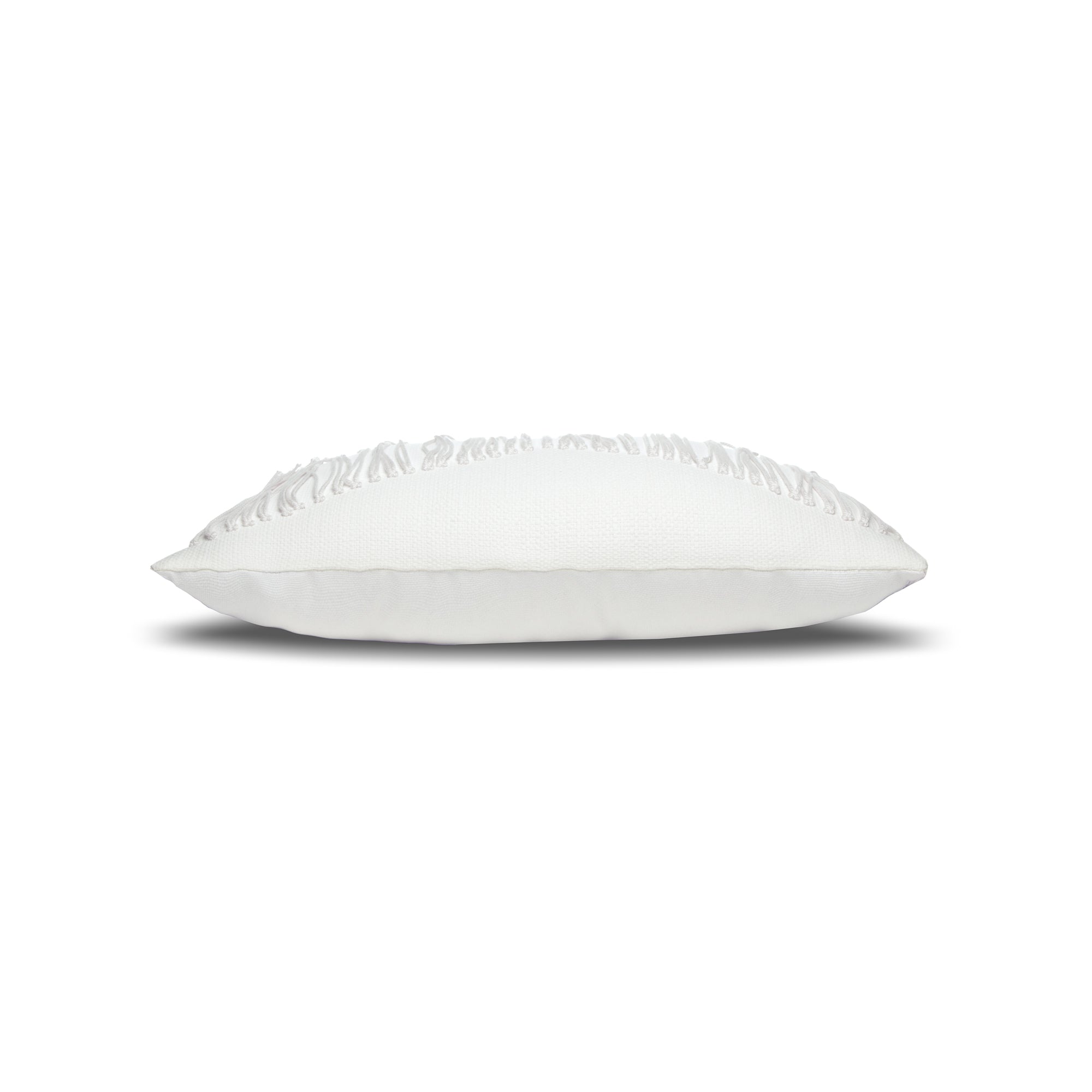 Side image of White textured outdoor pillow with fringe details and tassels on top corners for modern indoor and outdoor decor by Elaine Smith