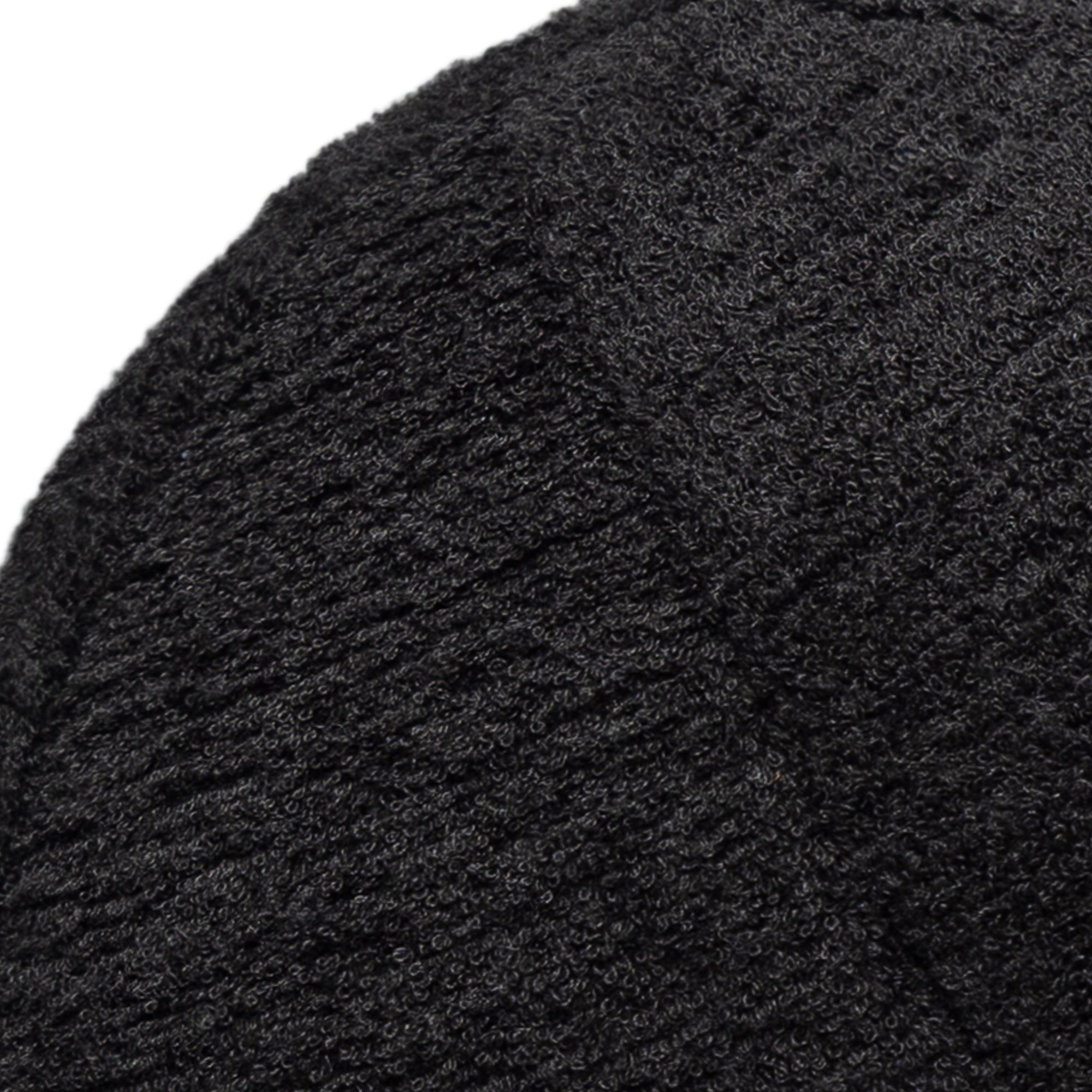 Detail image of Round plush black pillow with textured finish for chic indoor and outdoor decor