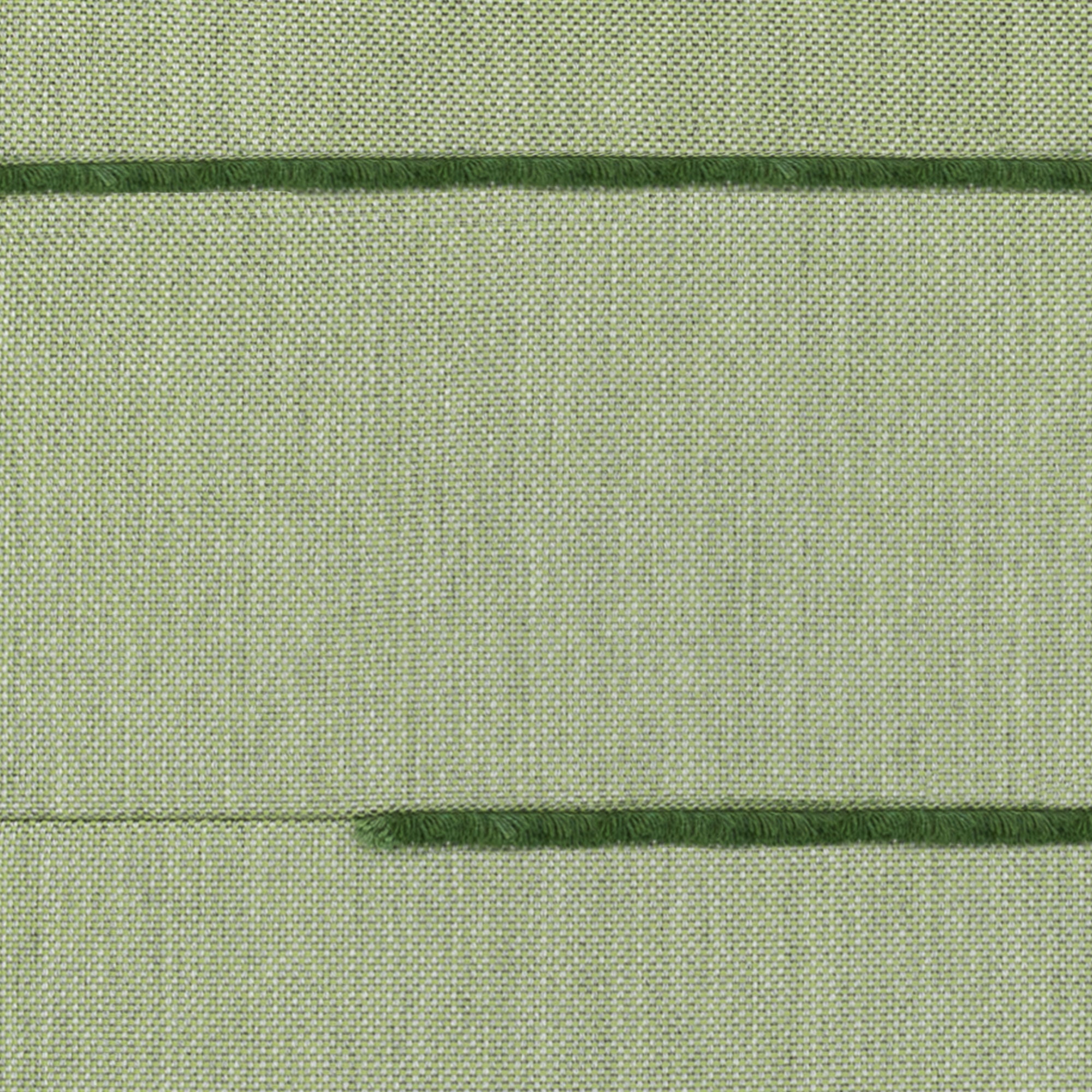 Close-up of green fabric with visible stitching