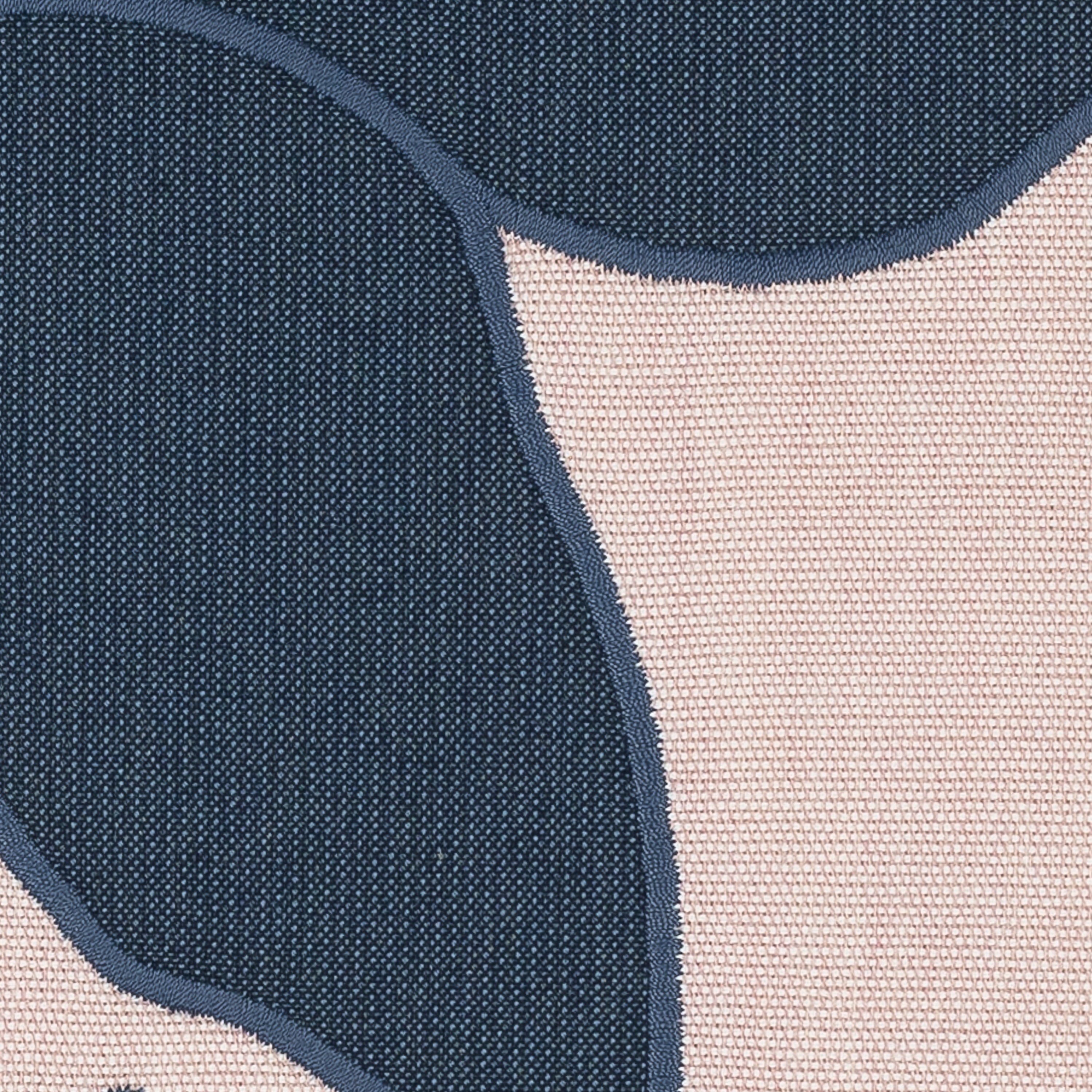 Detail image of Blush pink outdoor pillow with navy floral design for elegant patio styling