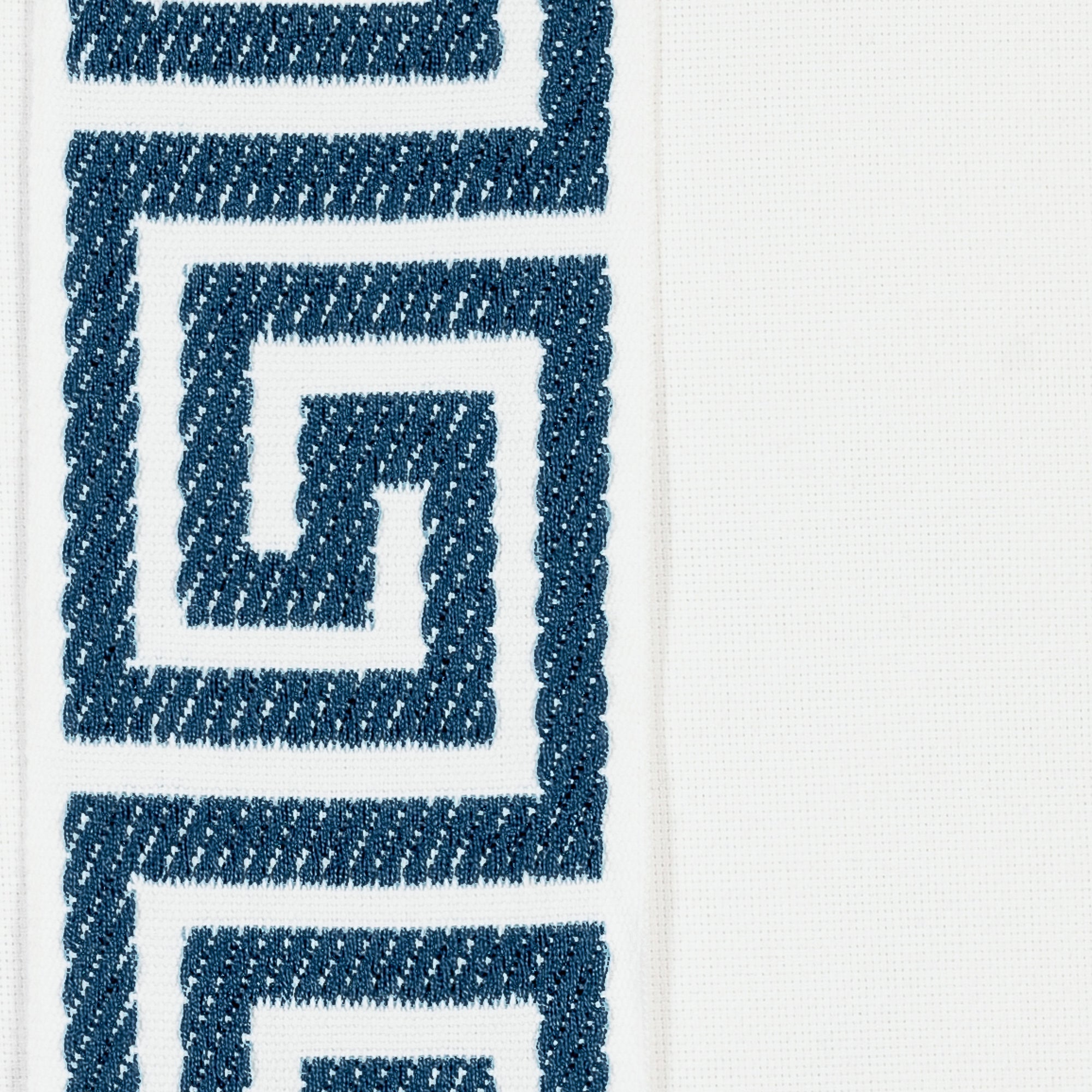 Detail image of White pillow with teal greek key band in lumbar size for indoor and outdoor décor