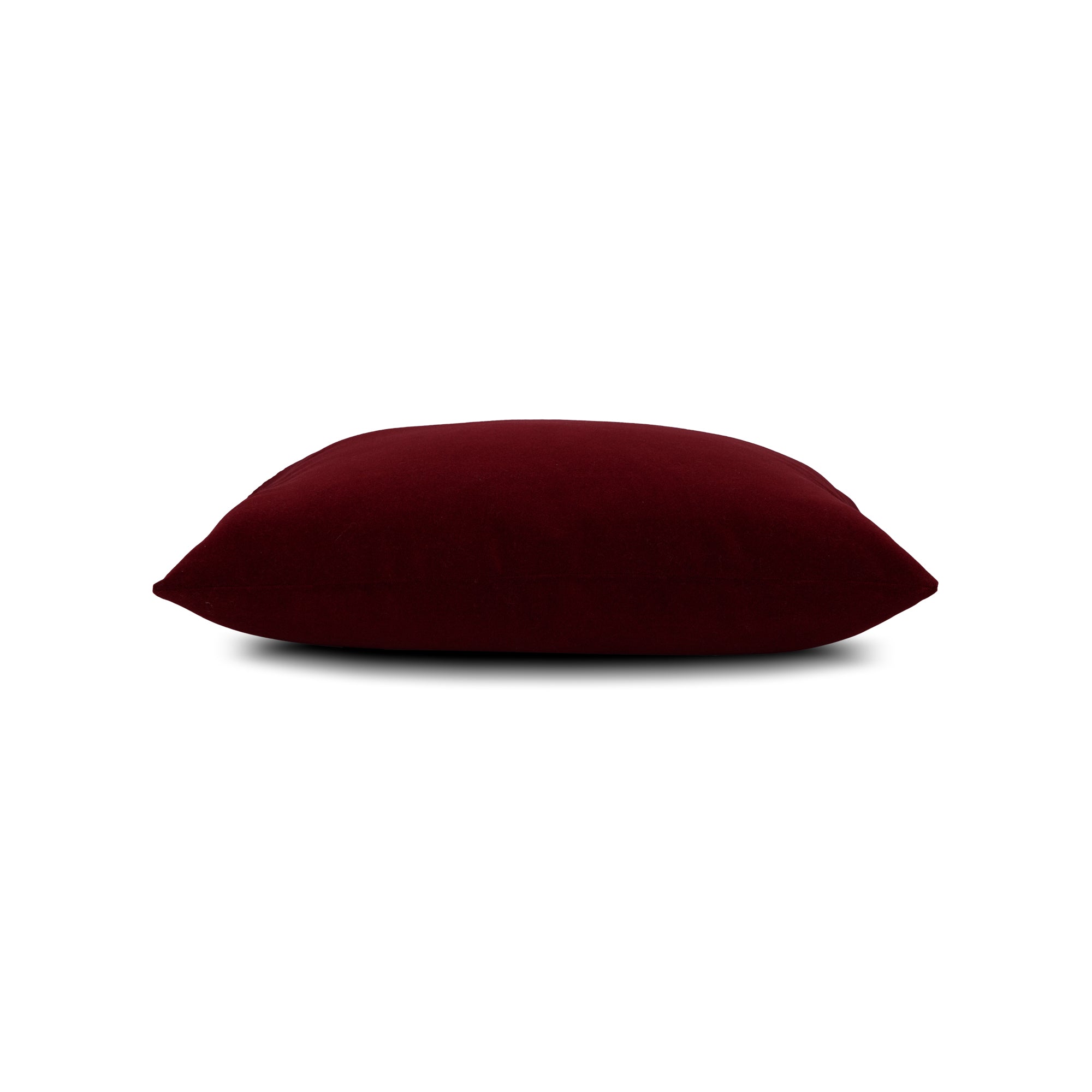 Side image of Red solid velvet pillow lumbar size for bold patio decor