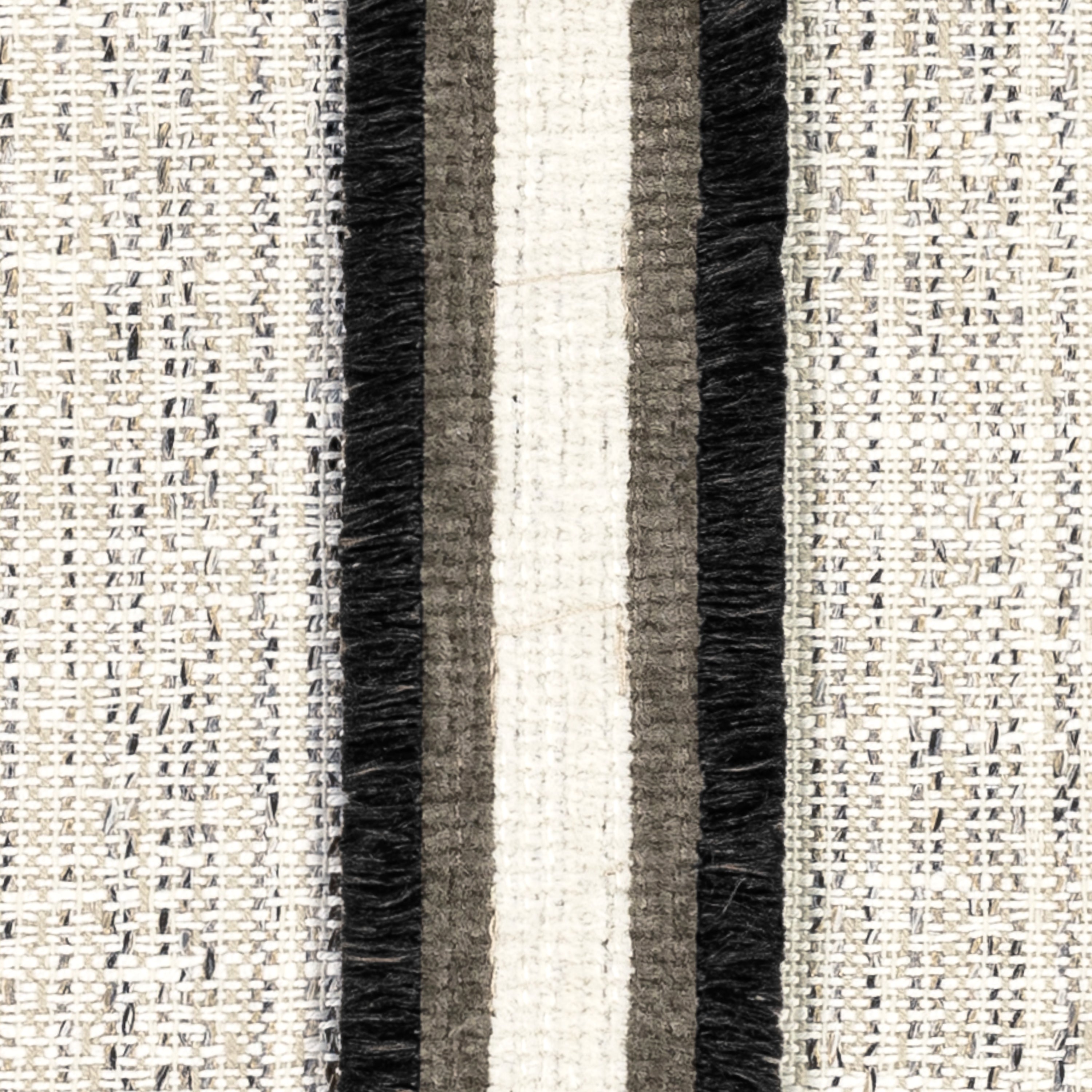 Detail image of Ivory and black lumbar outdoor pillow with textured finish and charcoal appliqued banding for stylish patio accents