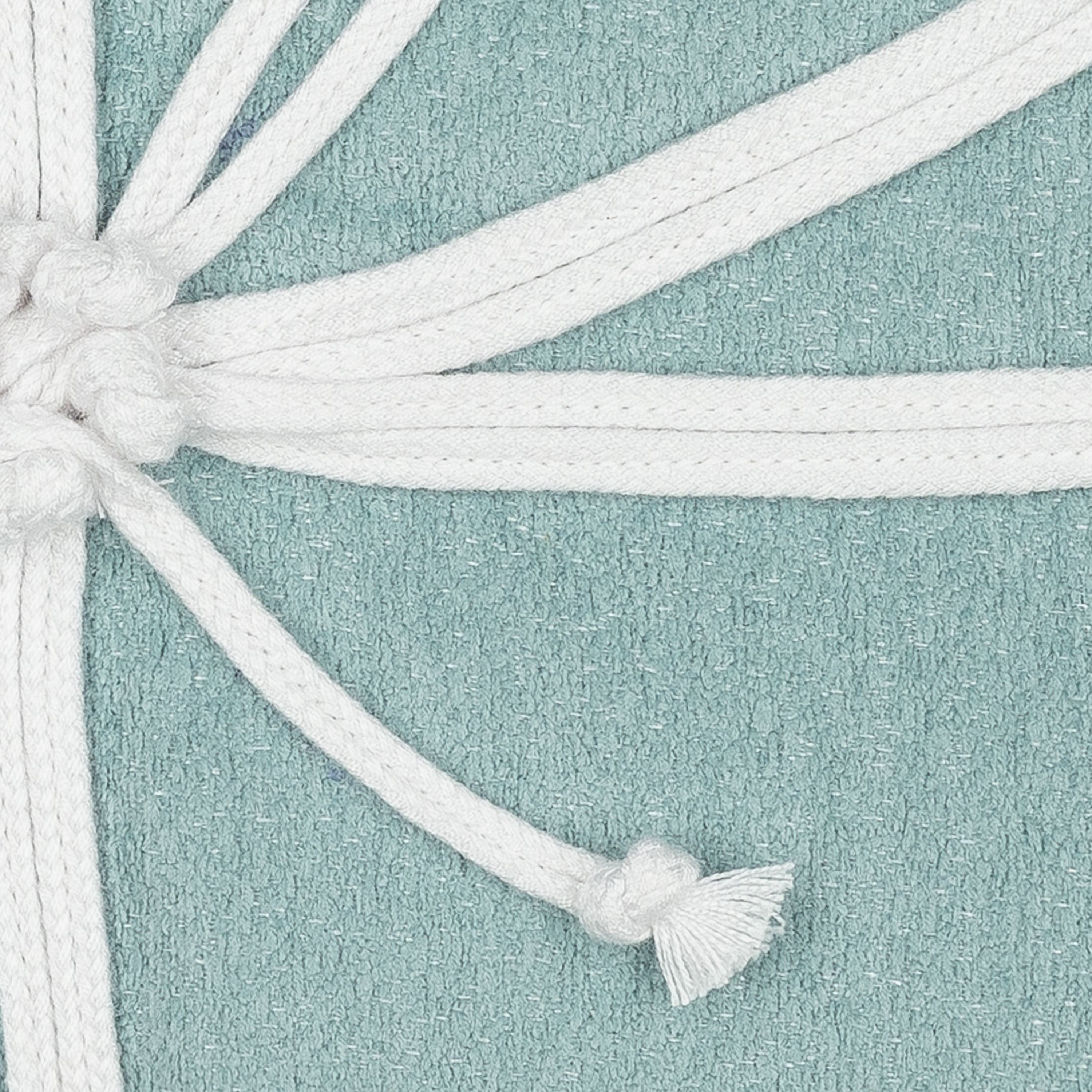Detail image of Soft aqua outdoor pillow with solid texture and stitched white flower in square size for soft patio decor by Elaine Smith