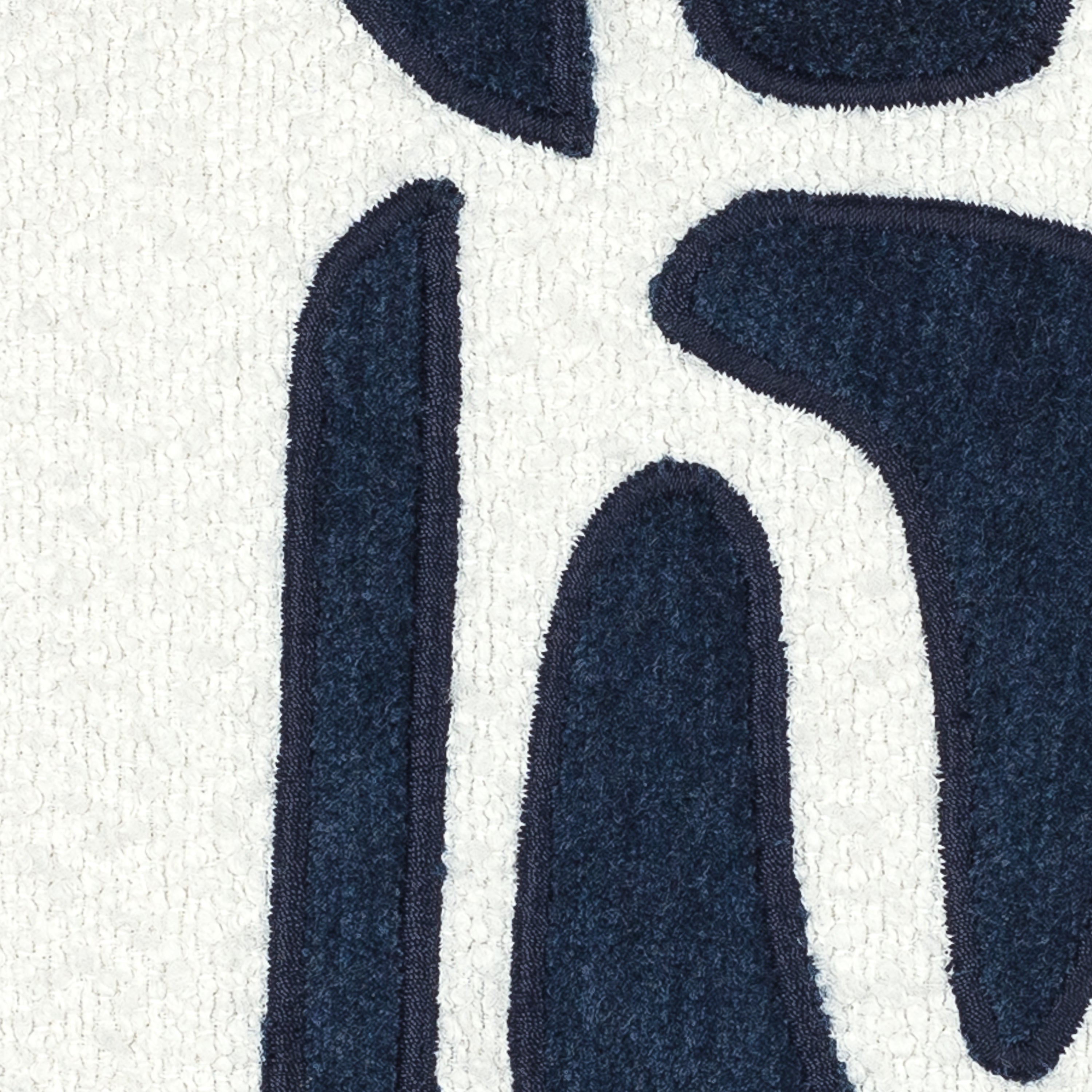 Detail image of Ivory textured pillow with indigo velour details in square size for chic indoor and outdoor decor