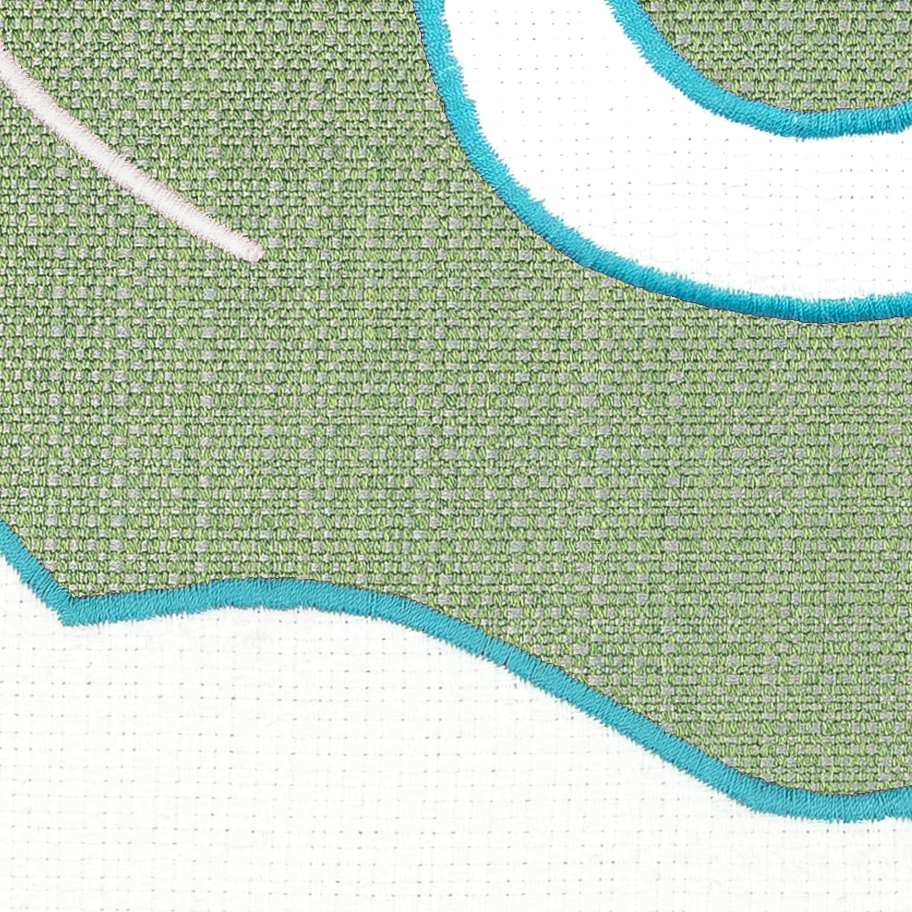 Detail image of Green and white western inspired design on outdoor pillow with aruba tassels for vibrant patio decor