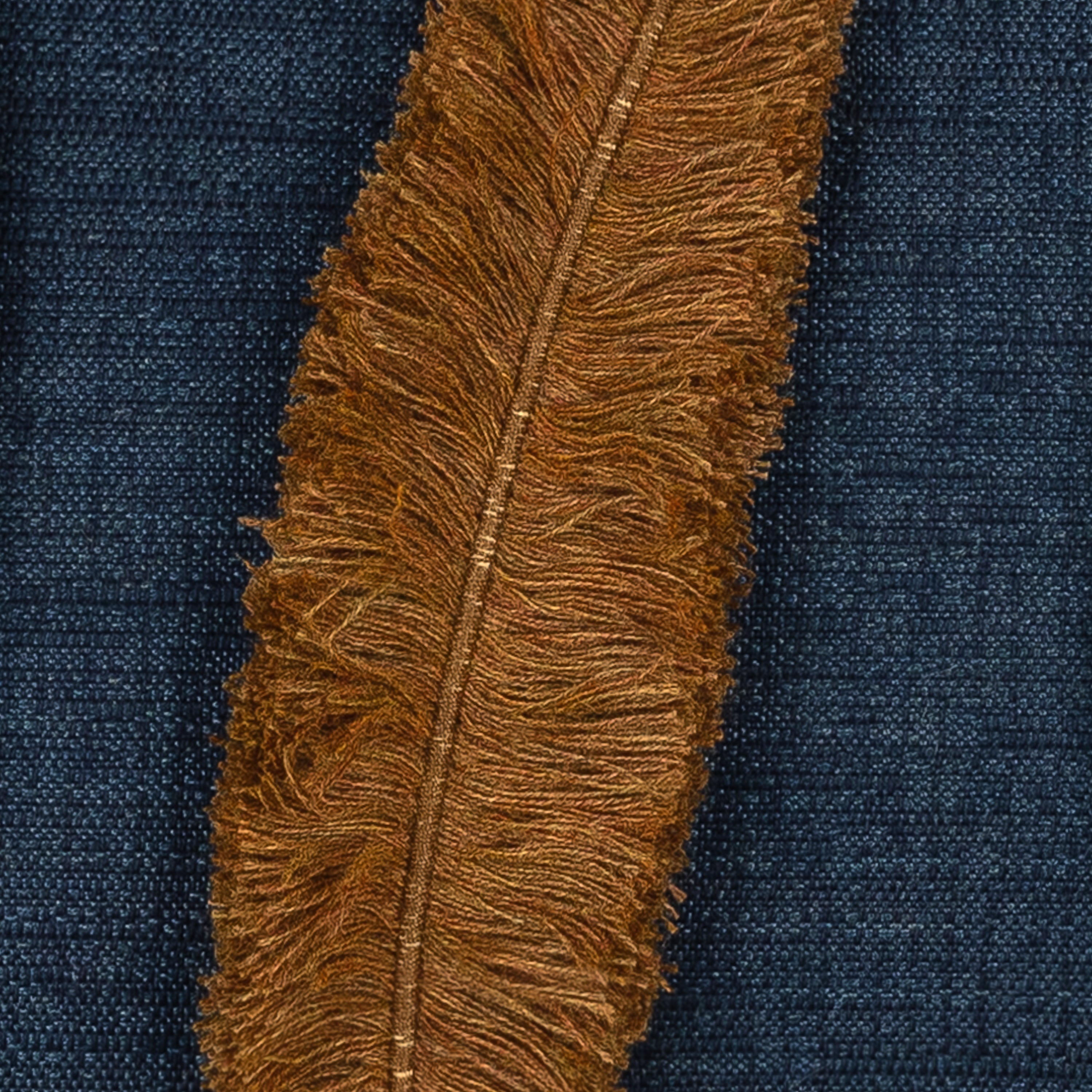 Detail image of Outdoor lumbar pillow in denim with appliqued leaf pattern for coordinated outdoor decor