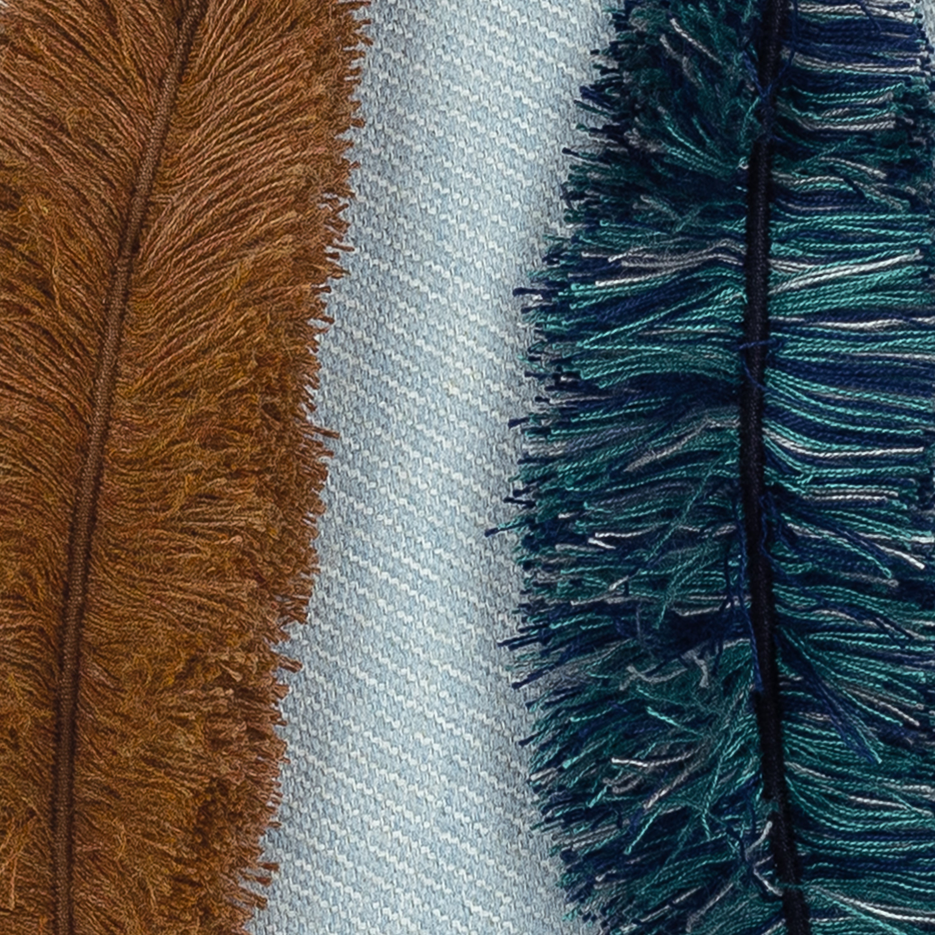 Detail image of Outdoor lumbar pillow in light blue with appliqued leaf pattern for coordinated outdoor decor