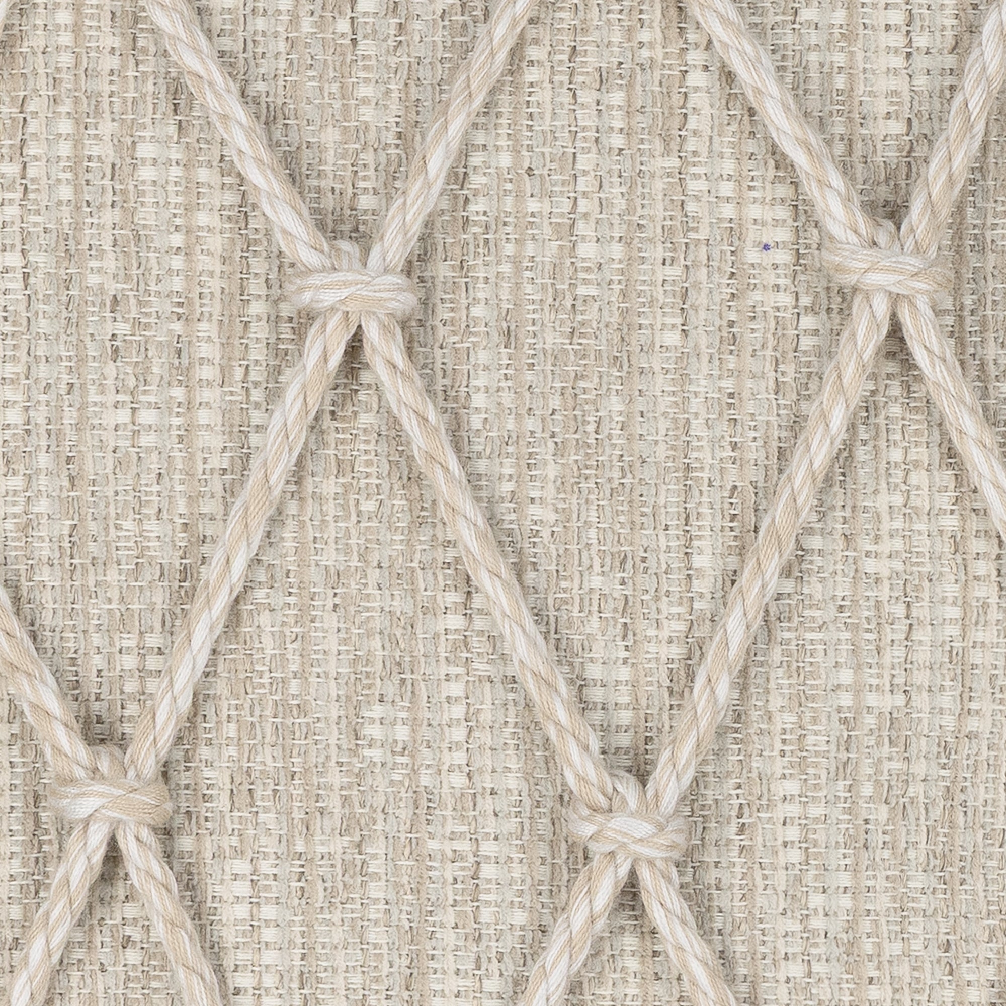 Detail image of Beige textured outdoor pillow with macrame rope diamond details, lumbar size for transitional indoor and outdoor decor by Elaine Smith