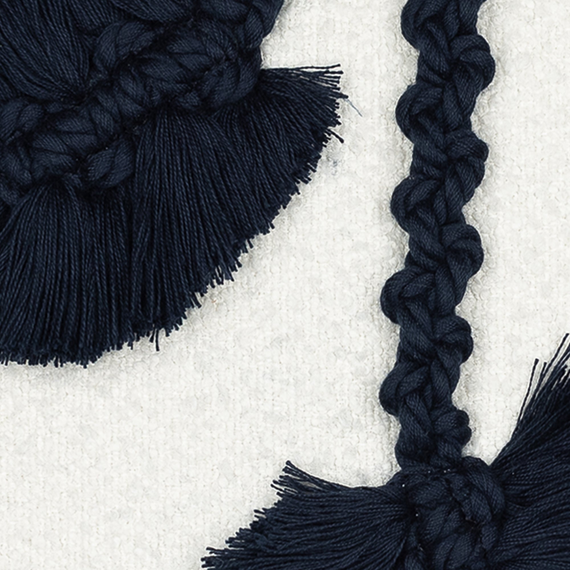 Detail image of Textured white outdoor pillow with abstract macrame leaf design in indigo square size for modern patio decor