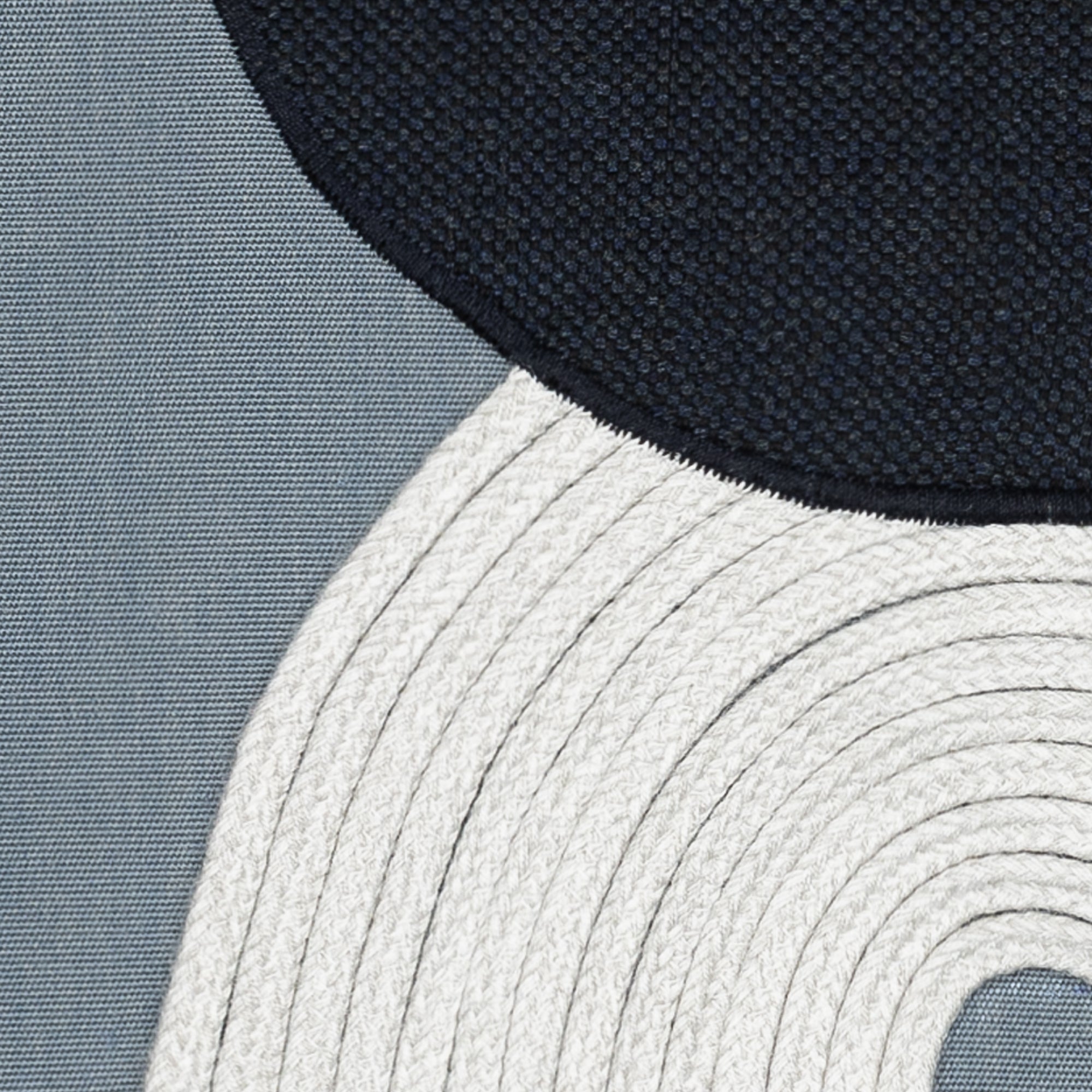 Detail image of Modern design hand stitched pillow on slate blue ground in square size for stylish indoor and outdoor decor by Elaine Smith