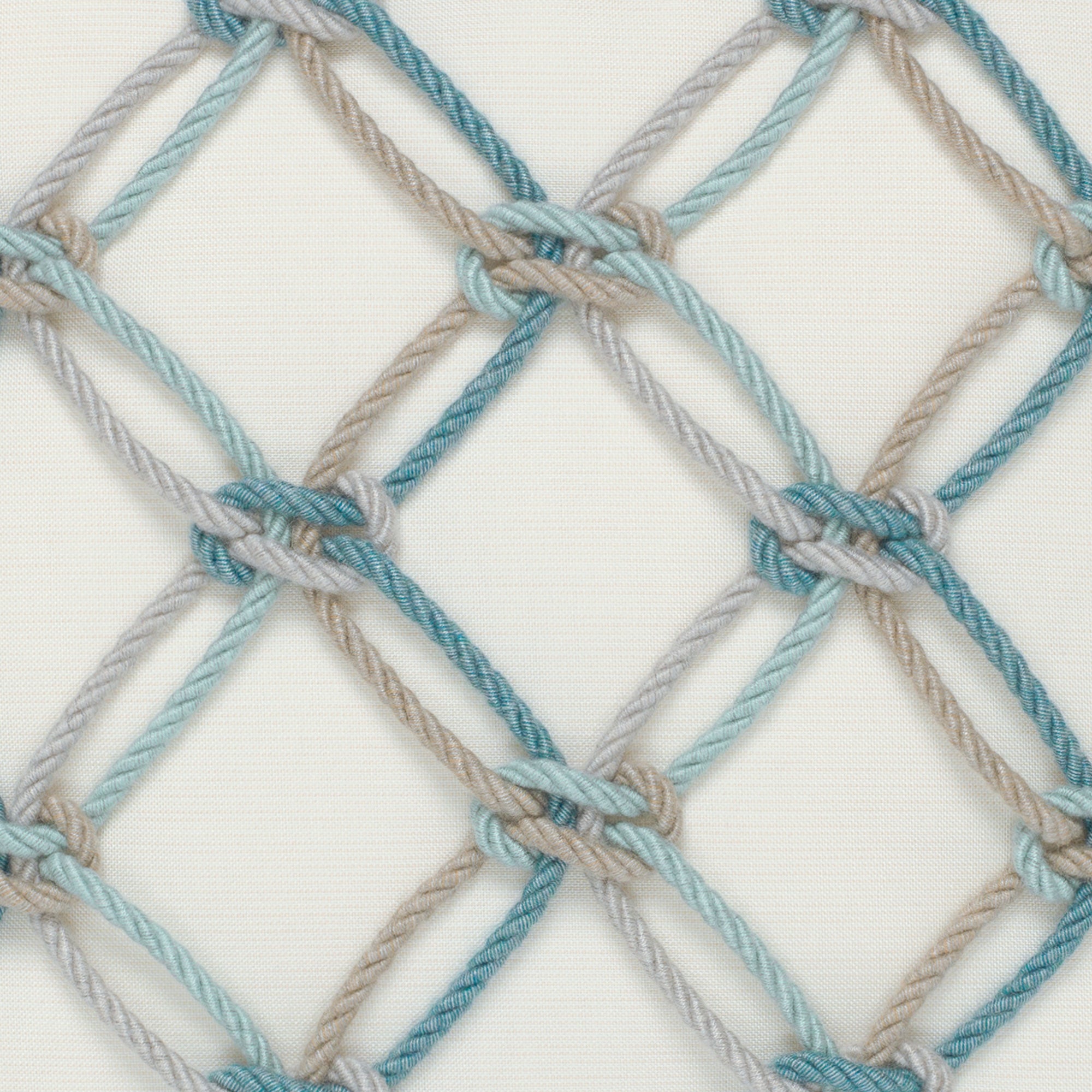 Detail image of Ivory lattice-pattern with aqua rope detail outdoor pillow for elegant outdoor spaces
