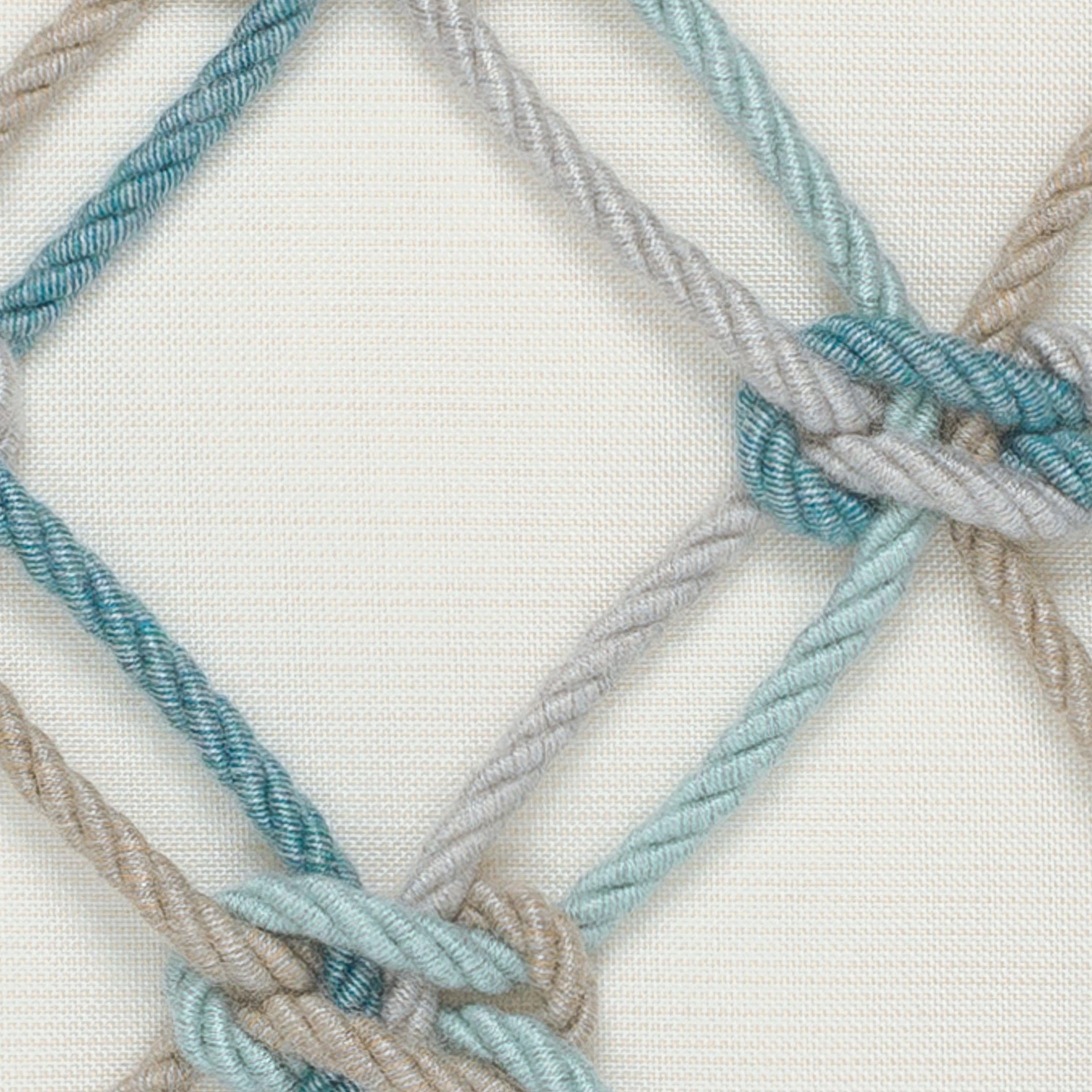 Detail image of Ivory lattice-pattern with aqua rope detail outdoor pillow for elegant outdoor spaces