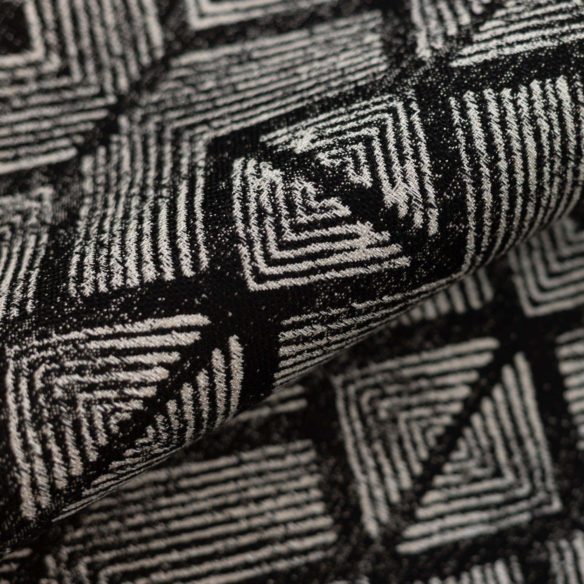 Close shot texture image of Tribal-inspired geometric outdoor safe fabric in ebony tones