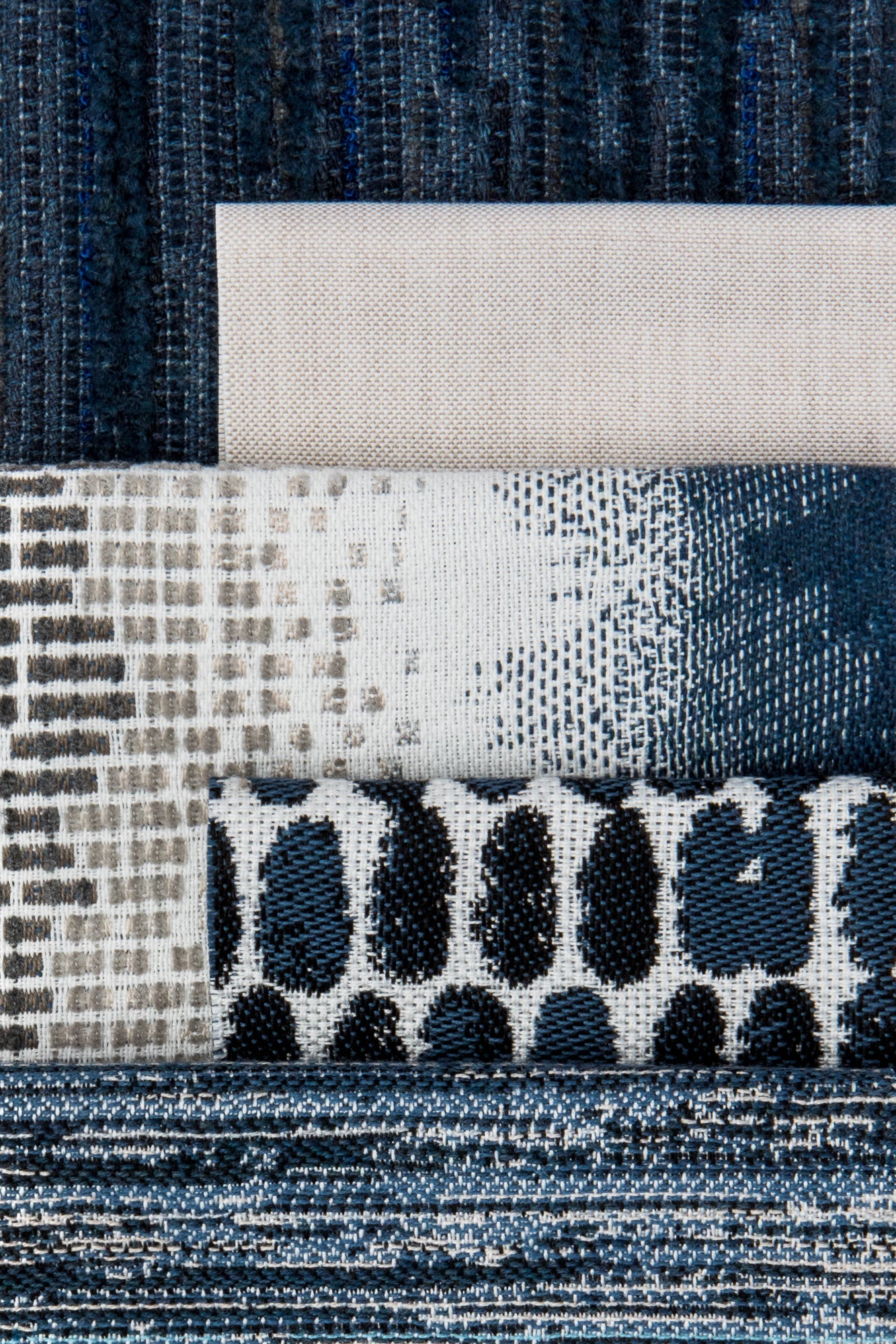 Coordinating fabrics to Collection of various textured fabric samples in blue, gray, and black from Elaine Smth