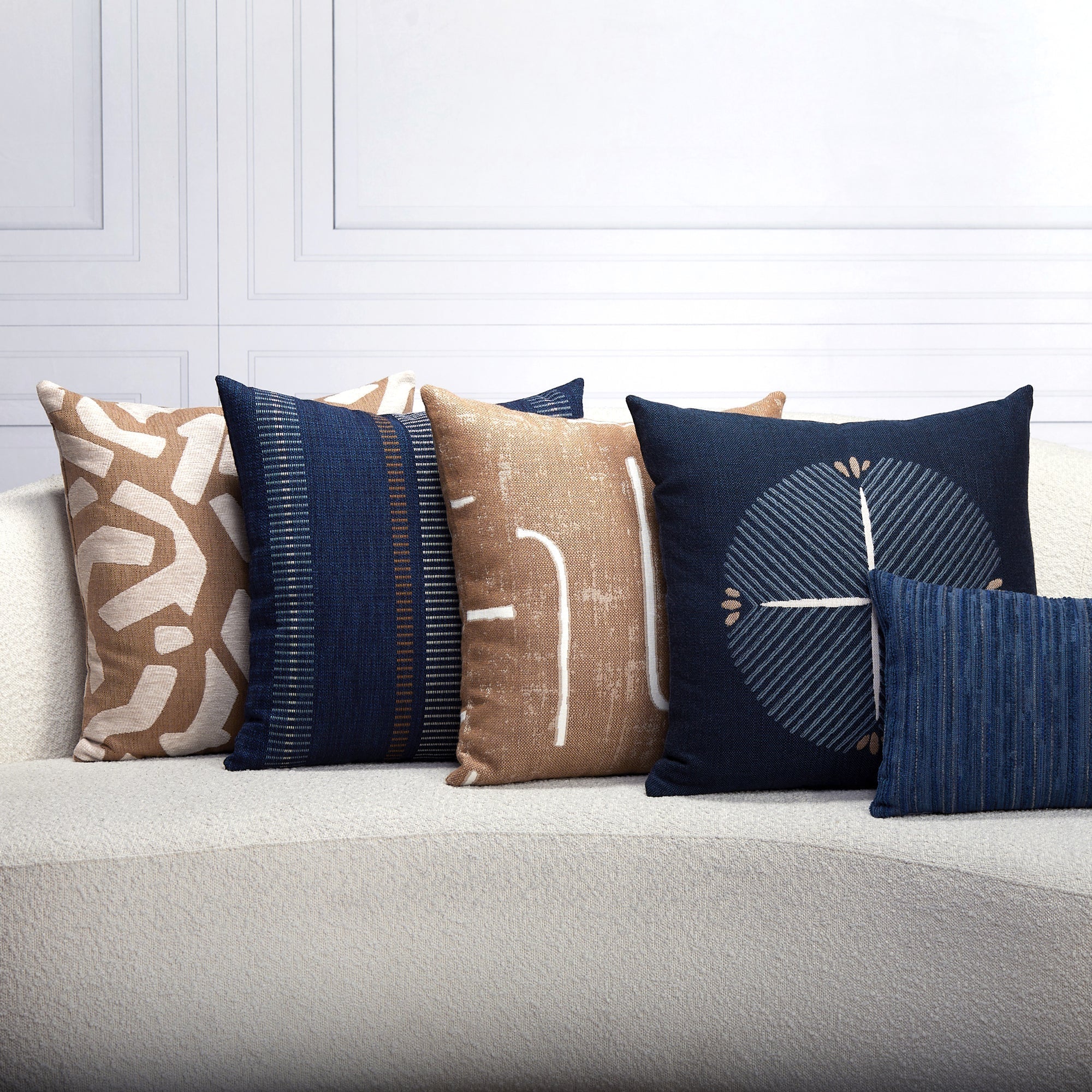 Indoor environmental image of pillows in Outdoor safe woven fabric with caramel abstract angular shapes