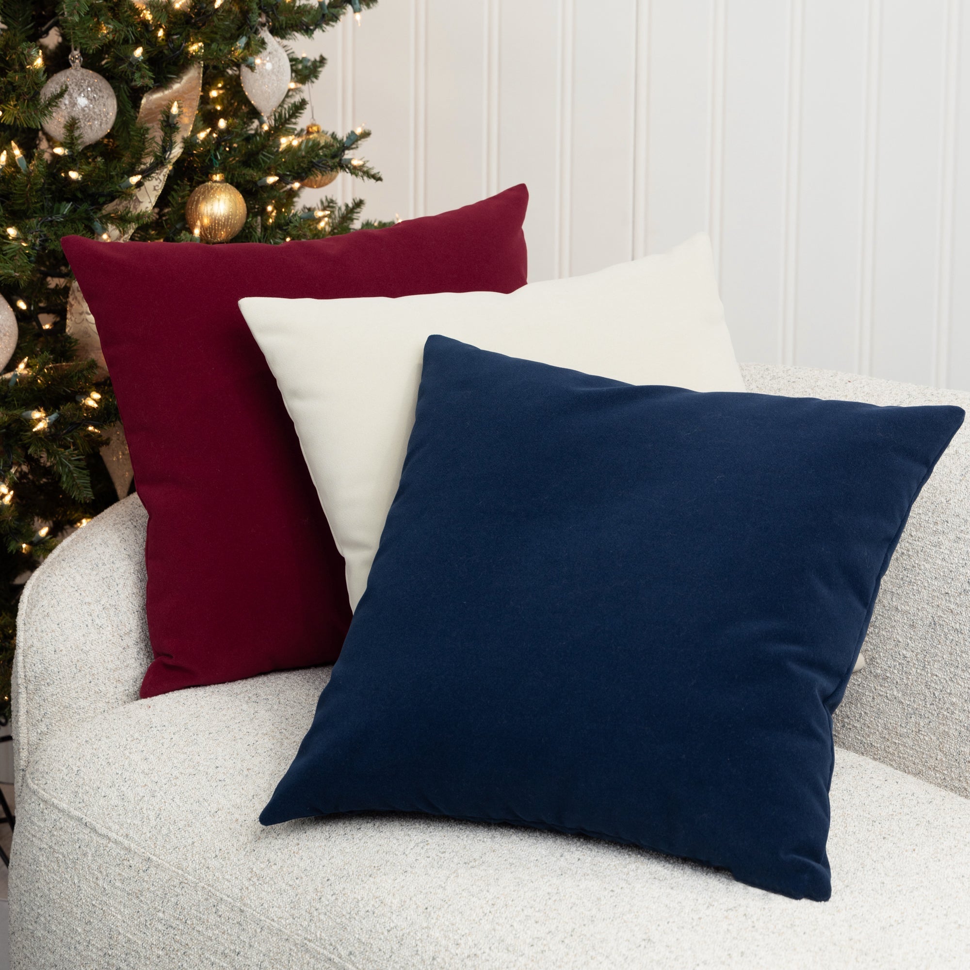 Indoor environmental image of square velvet pillows in various colors by elaine smith
