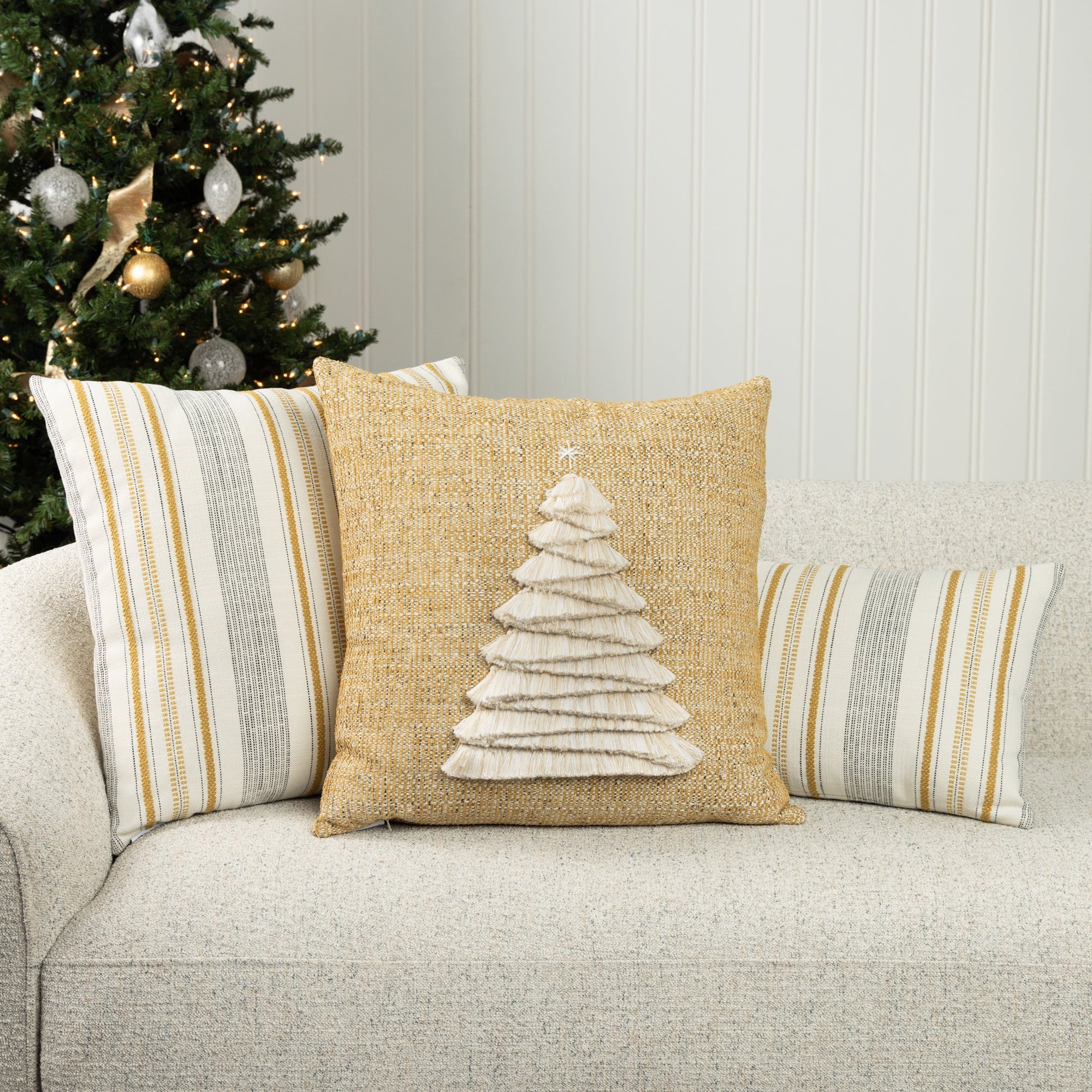 Gold and ivory holiday pillows on indoor sofa, woven textiles perfect for indoor and outdoor use
