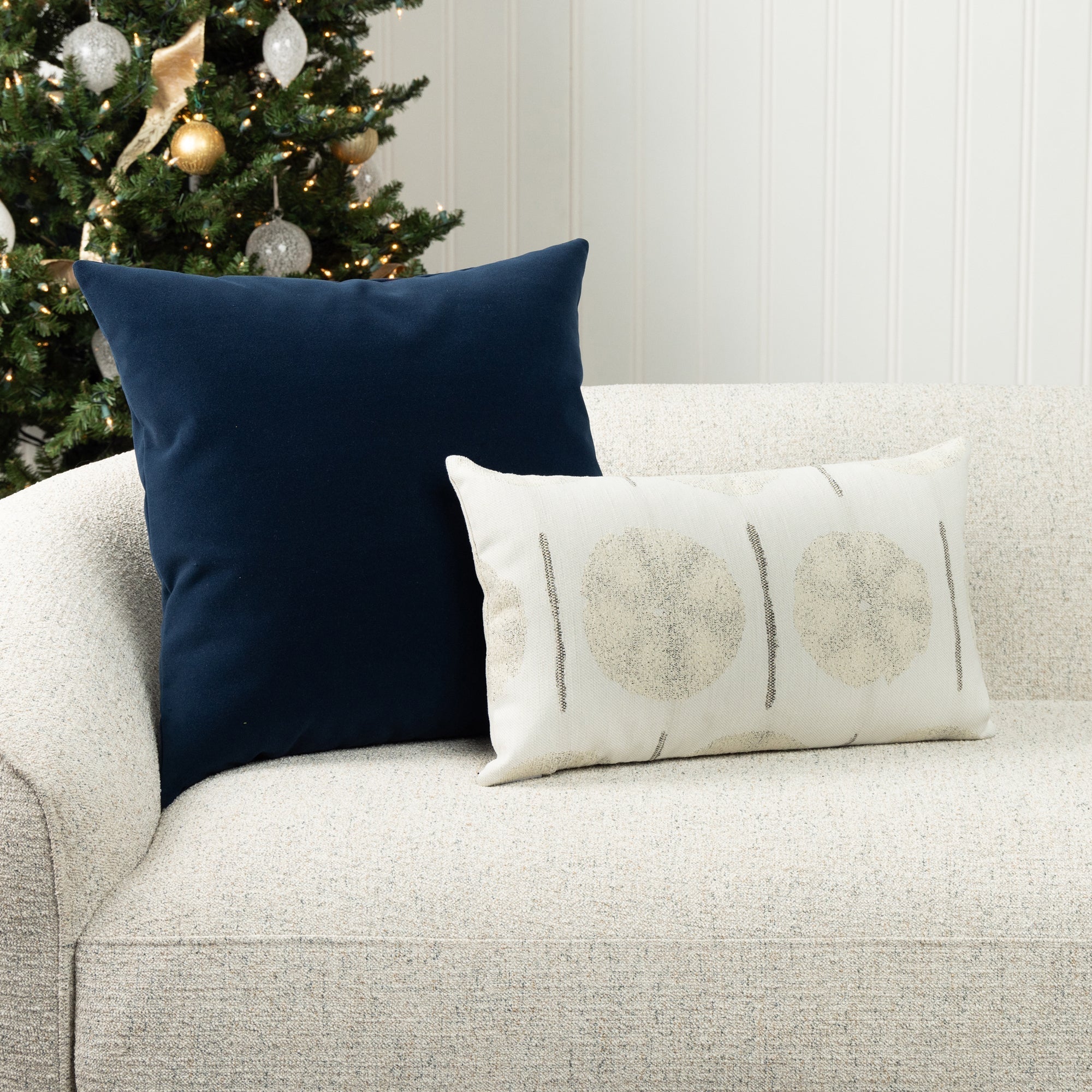 Navy and ivory holiday pillows on indoor sofa, woven textiles perfect for indoor and outdoor use