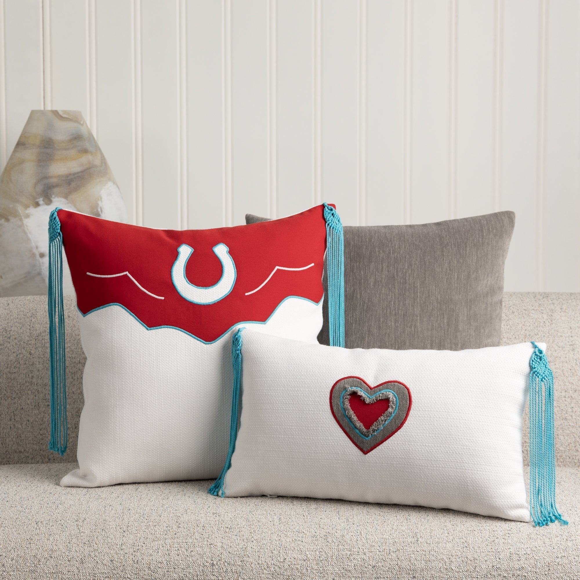 Indoor environmental image of pillows in Vivid red outdoor safe canvas fabric with bold solid finish