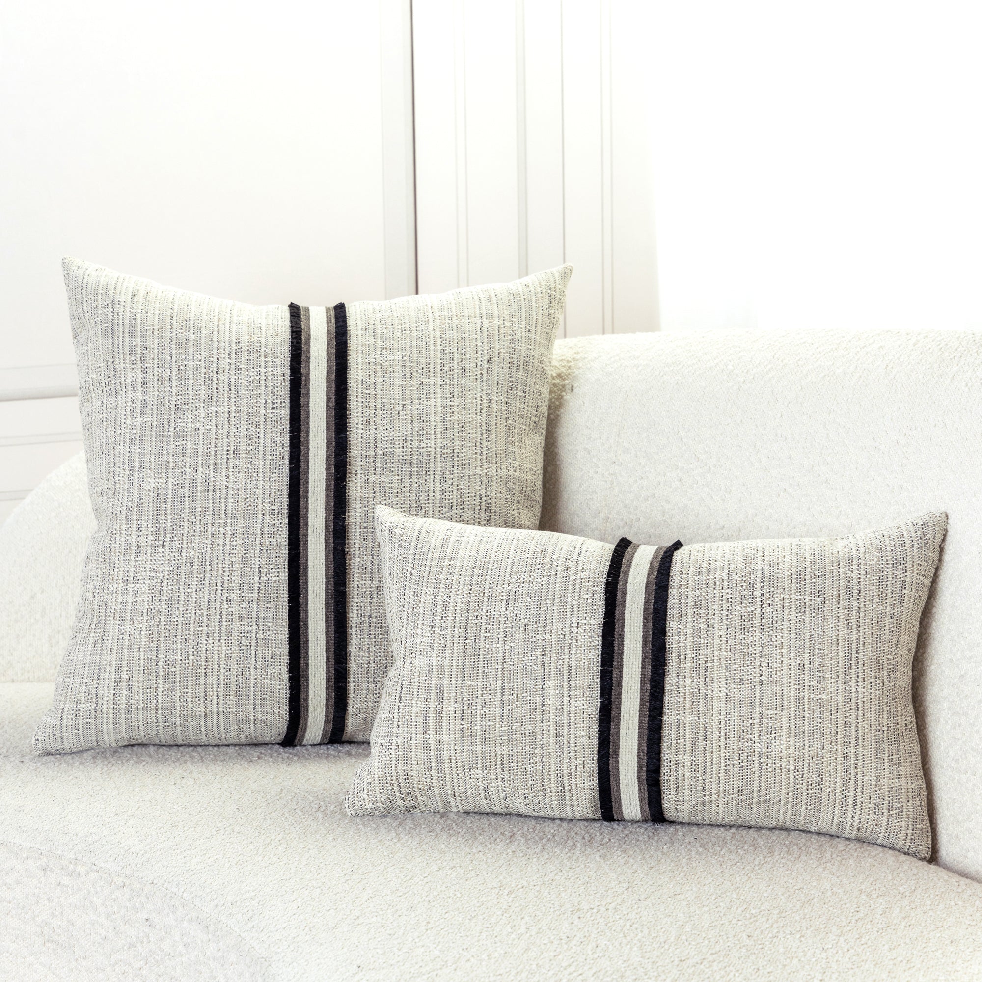 Indoor environmental image of pillows in Linen-inspired outdoor safe woven fabric in soft neutral tones
