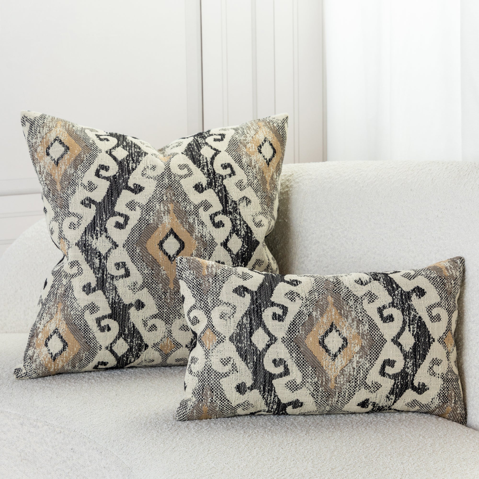 Luxury pillows in textured golden ikat woven pattern in ivory sofa by elaine smith