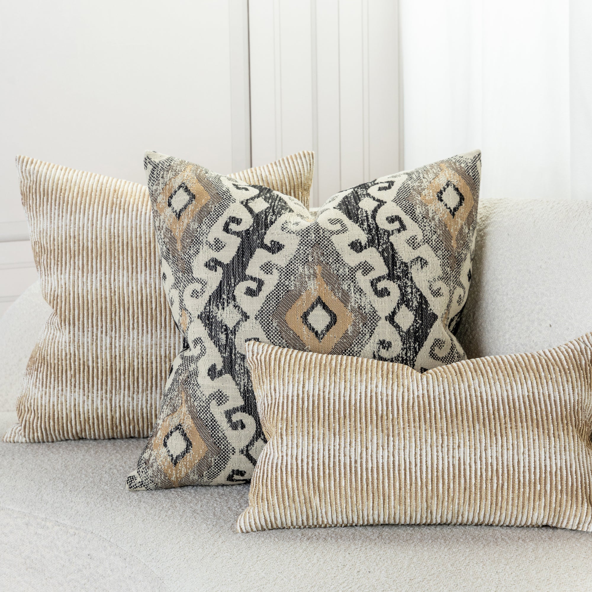 Luxury pillows in textured golden ikat woven pattern in ivory sofa by elaine smith