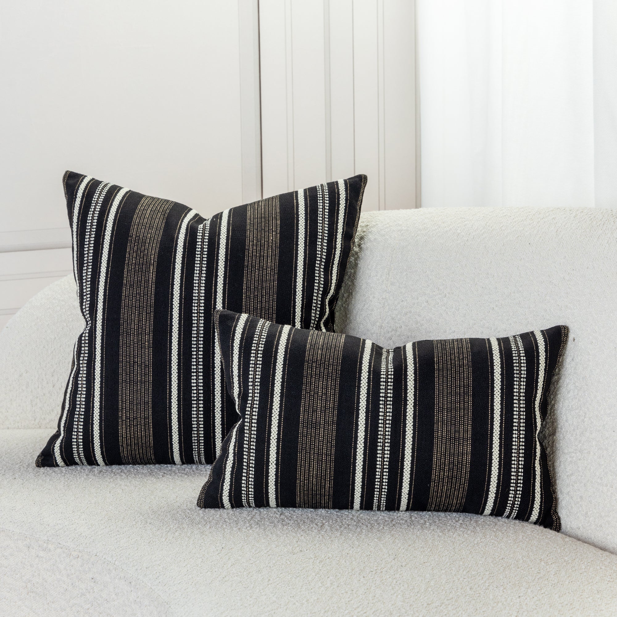 Gold and ivory striped pillows in ivory sofa by elaine smith