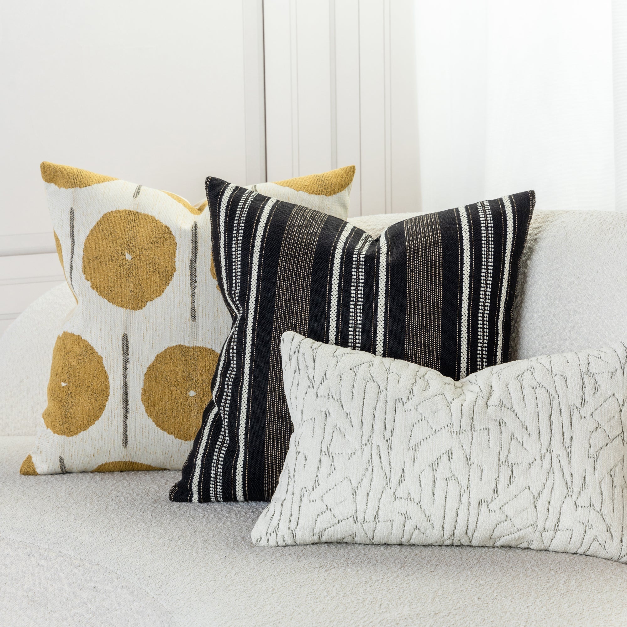 Gold and ivory striped pillows in ivory sofa by elaine smith