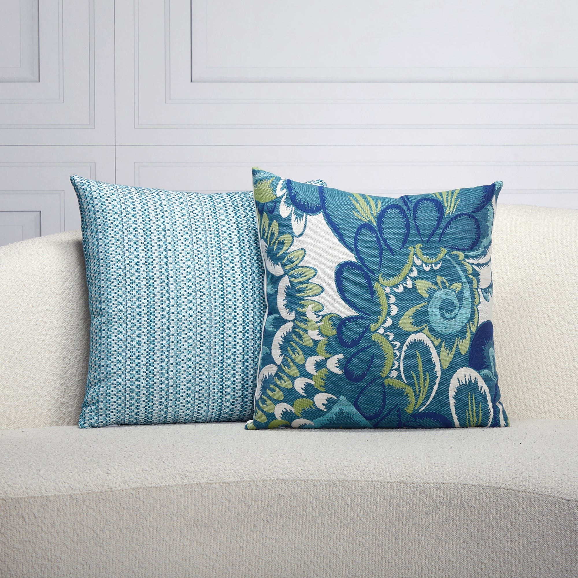 Indoor environmental image of pillows in Lagoon blue multi-colored chenille kaleidoscope pattern outdoor safe woven fabric