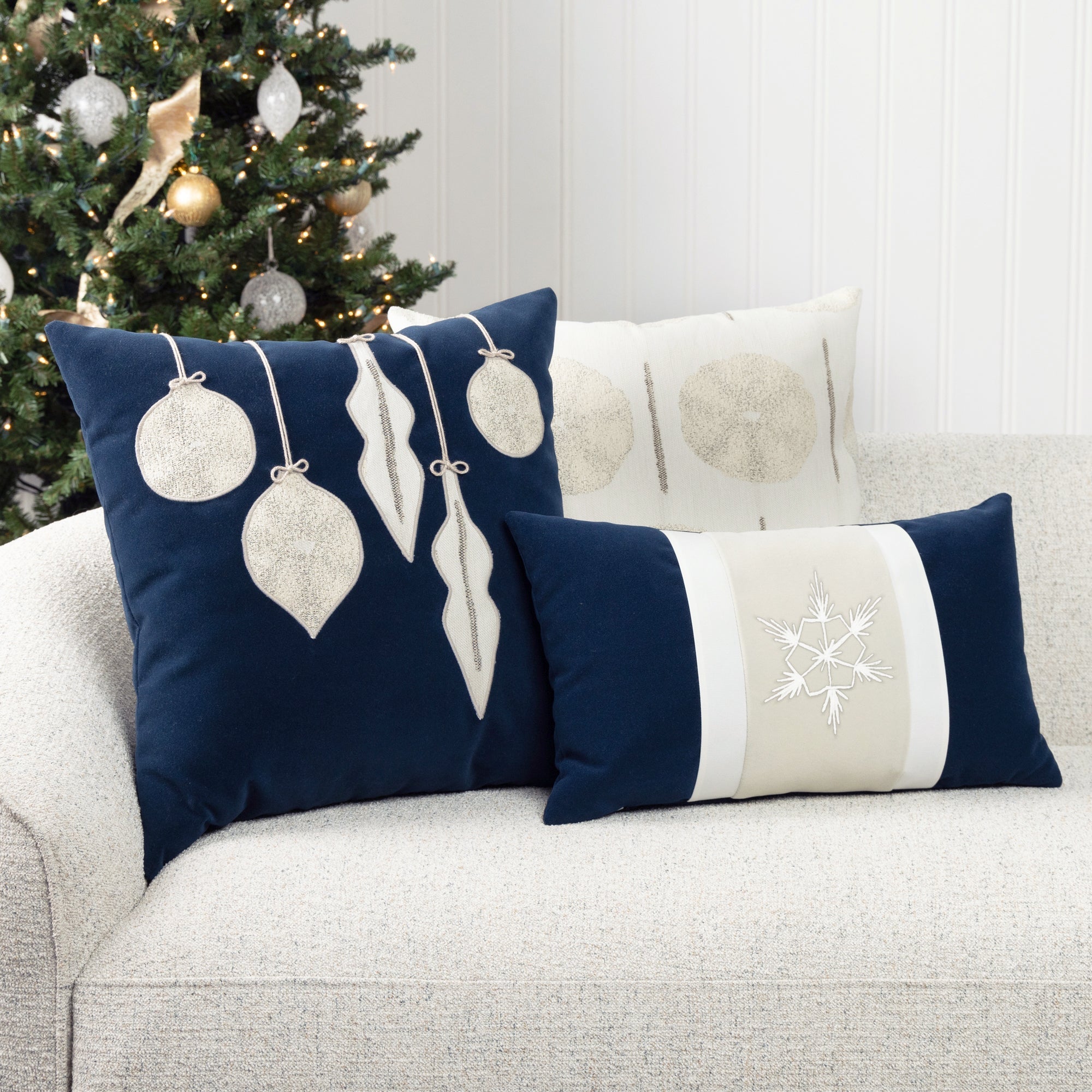 Luxury holiday image of ornament pillow in navy with ivory accents, outdoor safe by elaine smith