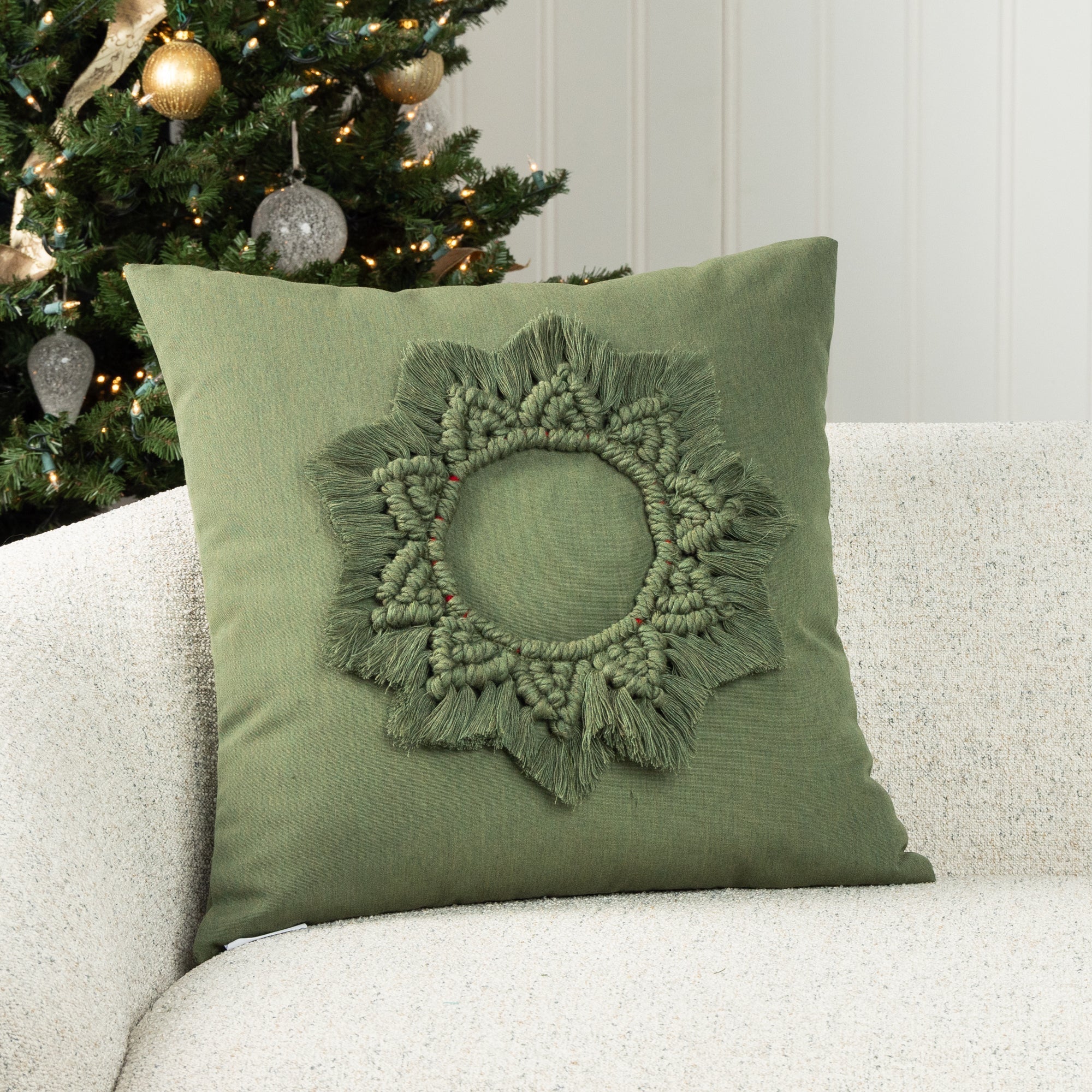 Luxury holiday image of green accent pillow with hand stitched wreath accents, outdoor safe by elaine smith