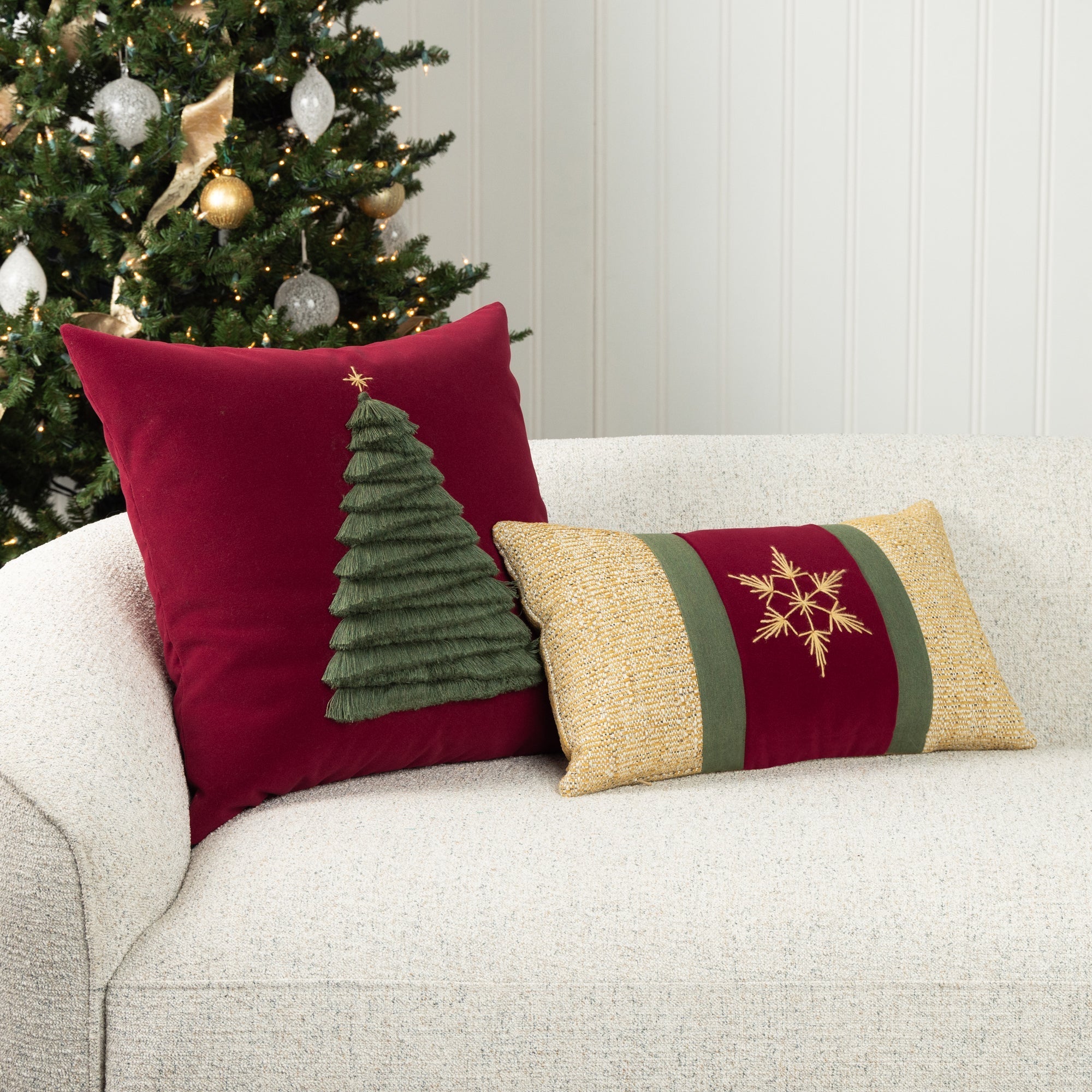 Luxury holiday image of ruby velvet holiday accent pillow with hand stitched holiday tree accents and gold and ruby lumbar pillow both are outdoor safe by elaine smith