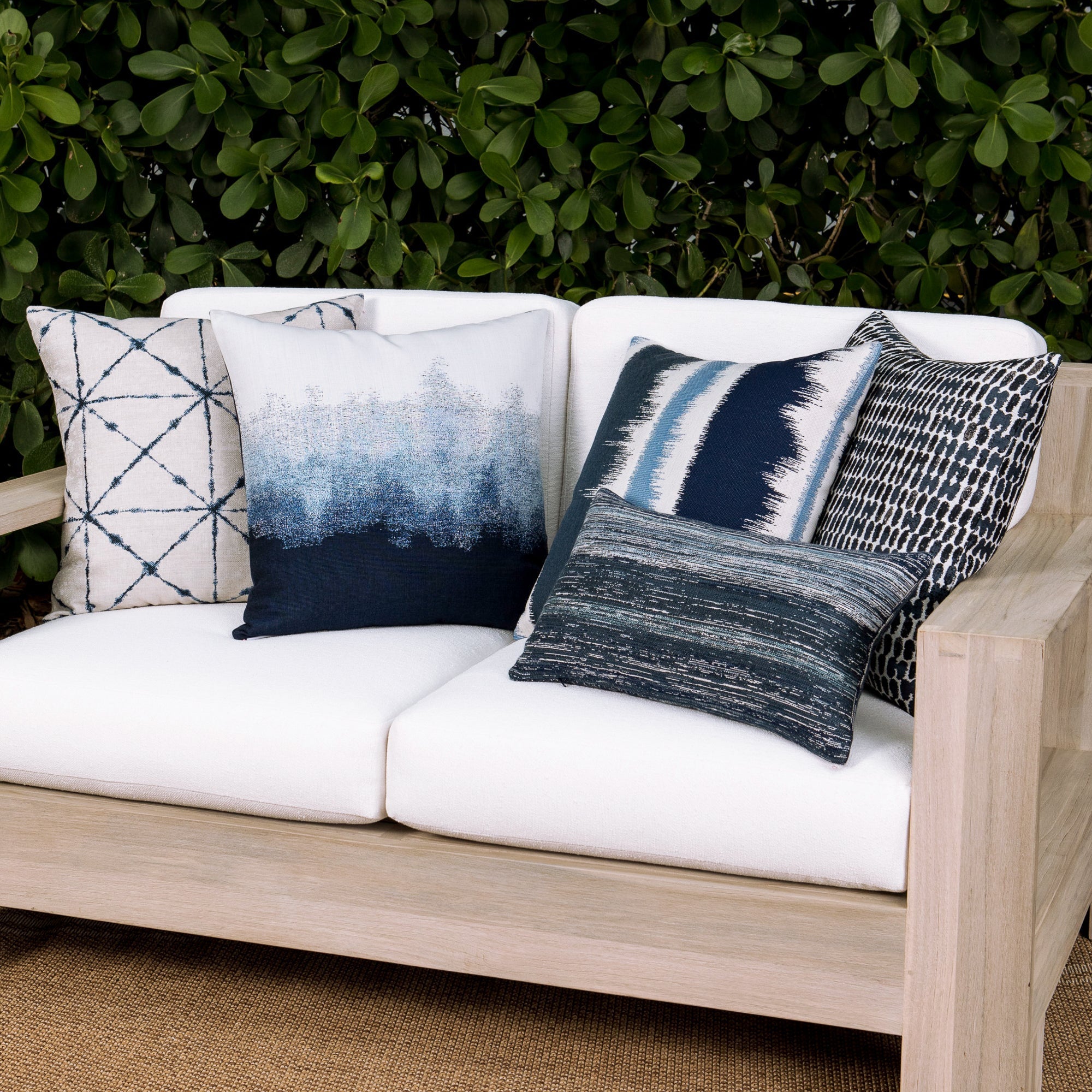 Outdoor image of pillows in Indigo outdoor safe woven textile with streaked texture effect