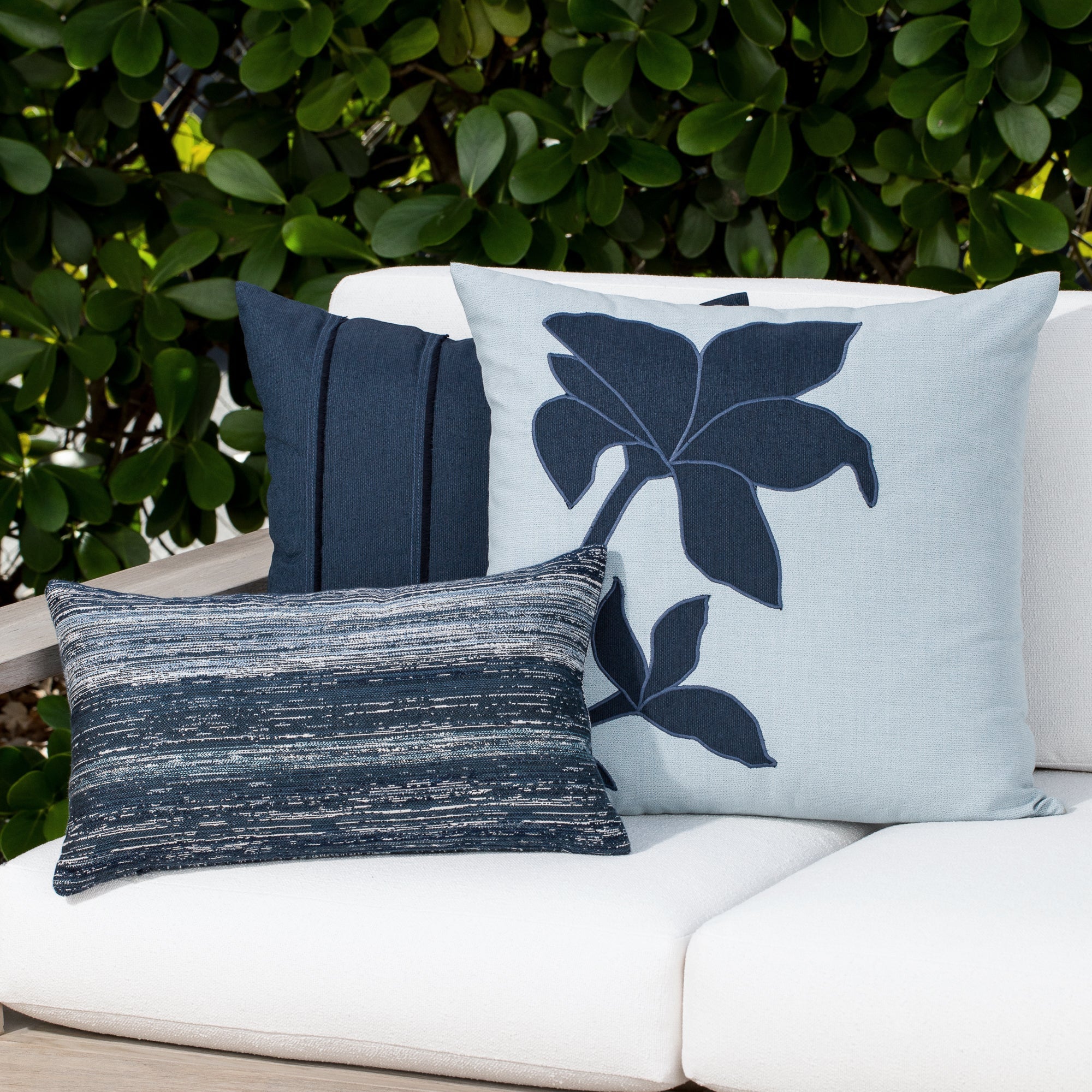 Outdoor image of pillows in Indigo outdoor safe woven textile with streaked texture effect