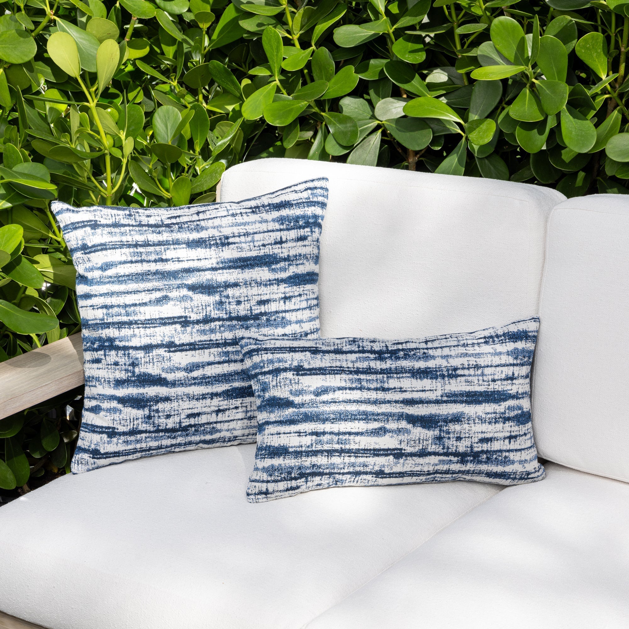 Outdoor image of pillows in Indigo blue streaked linear pattern outdoor safe fabric – Linear Indigo by Elaine Smith