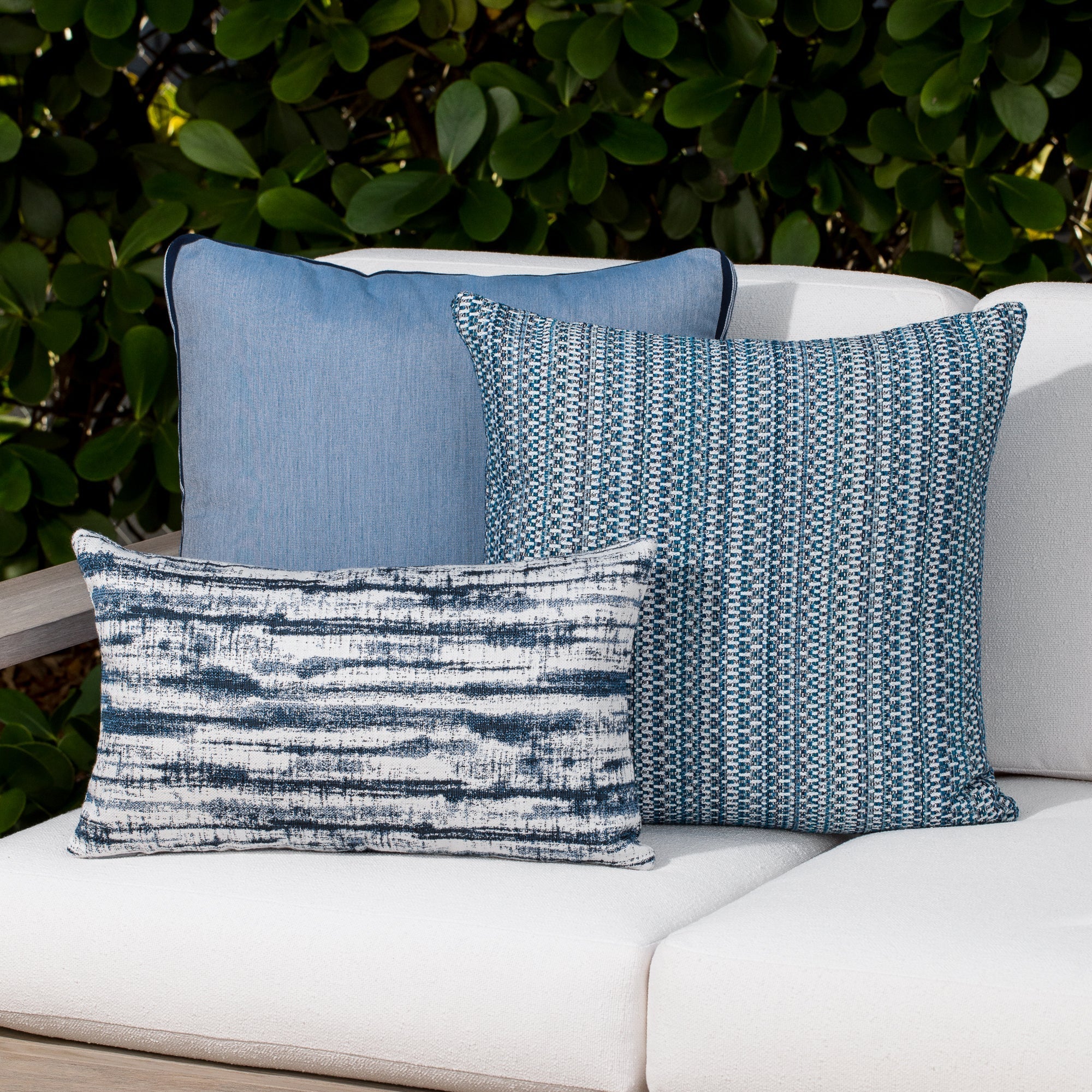 Outdoor image of pillows in Indigo blue streaked linear pattern outdoor safe fabric – Linear Indigo by Elaine Smith