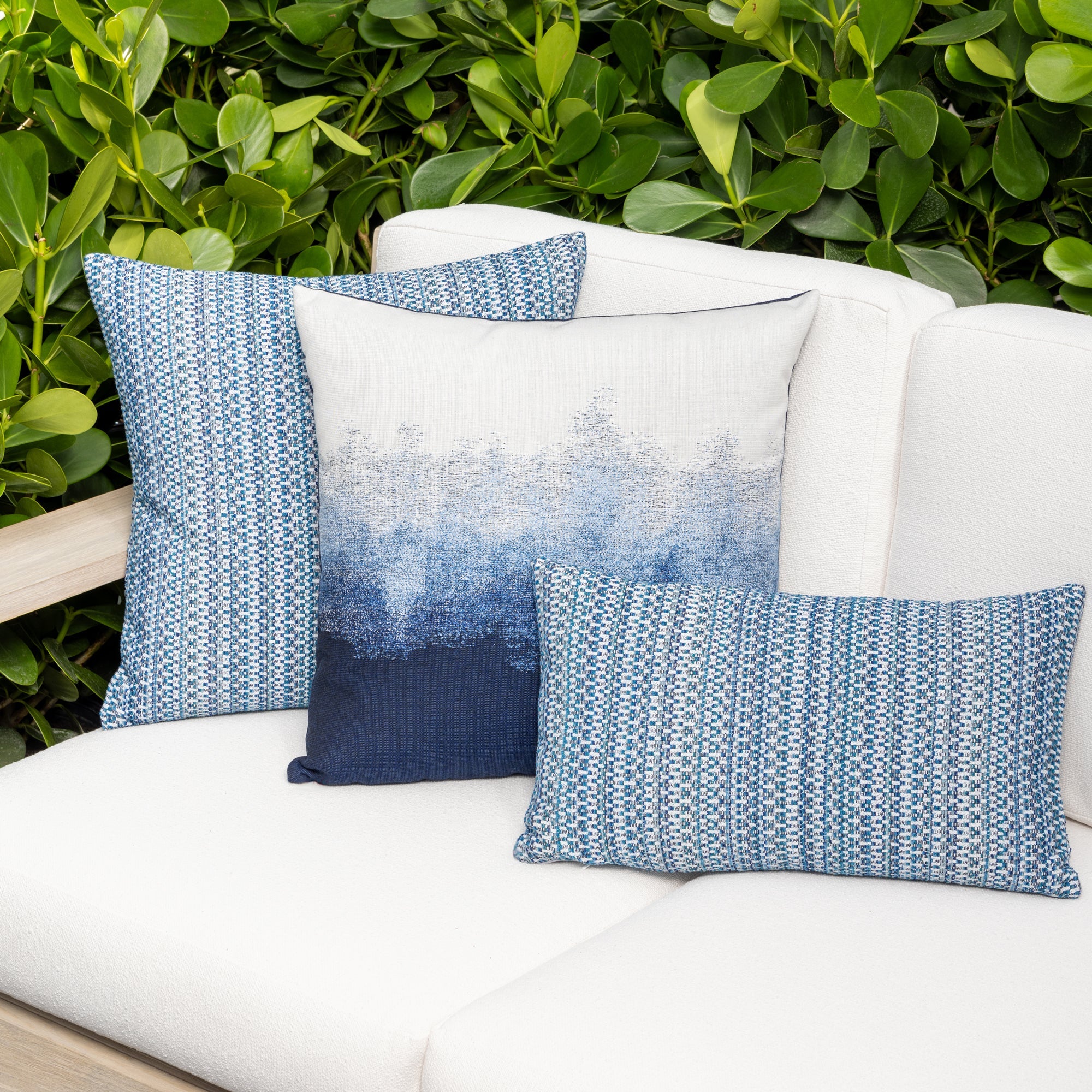Outdoor image of pillows in Indigo-colored multi-colored chenille kaleidoscope design in performance outdoor safe fabric