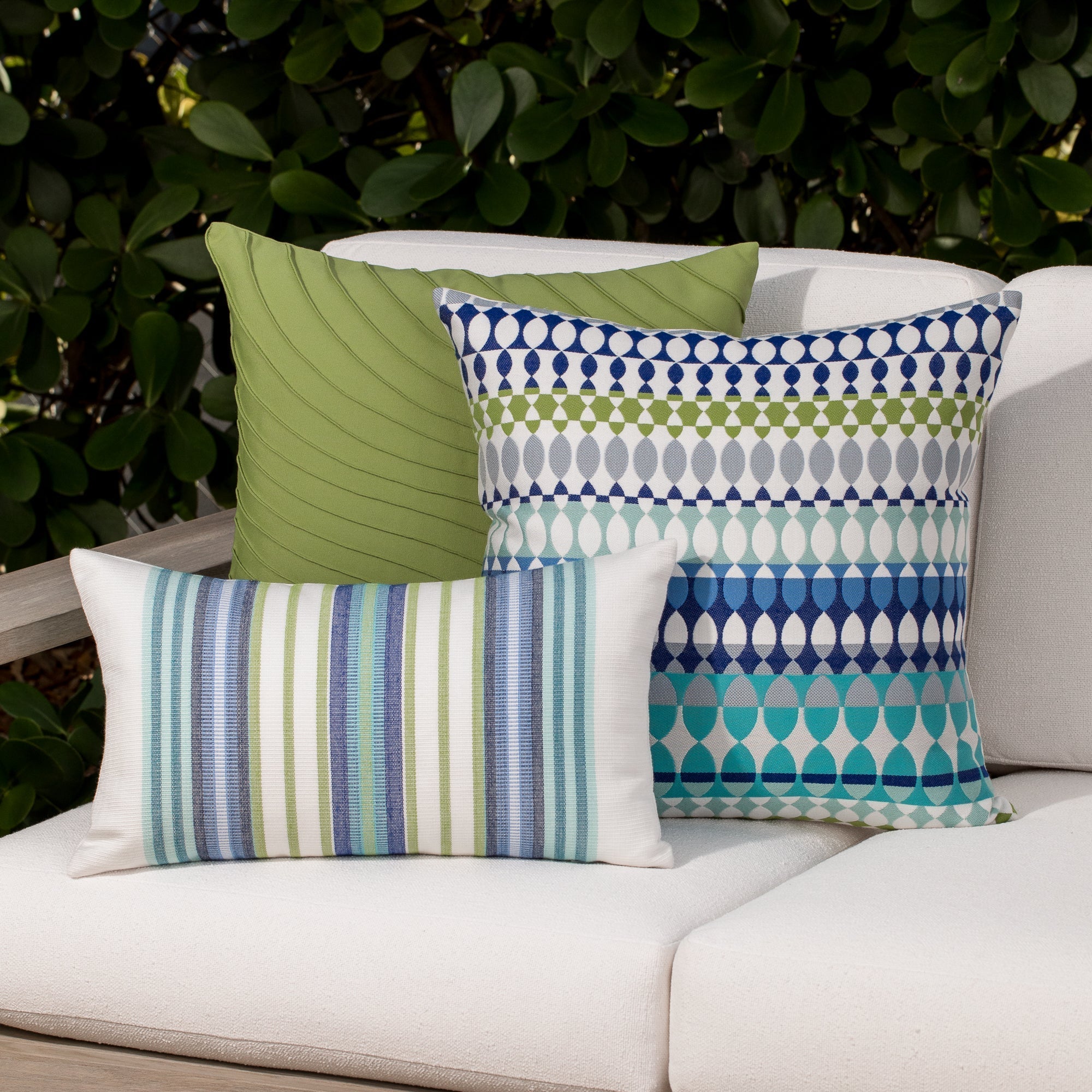 Outdoor image of pillows in Contemporary oval patterned outdoor safe fabric in blue and green