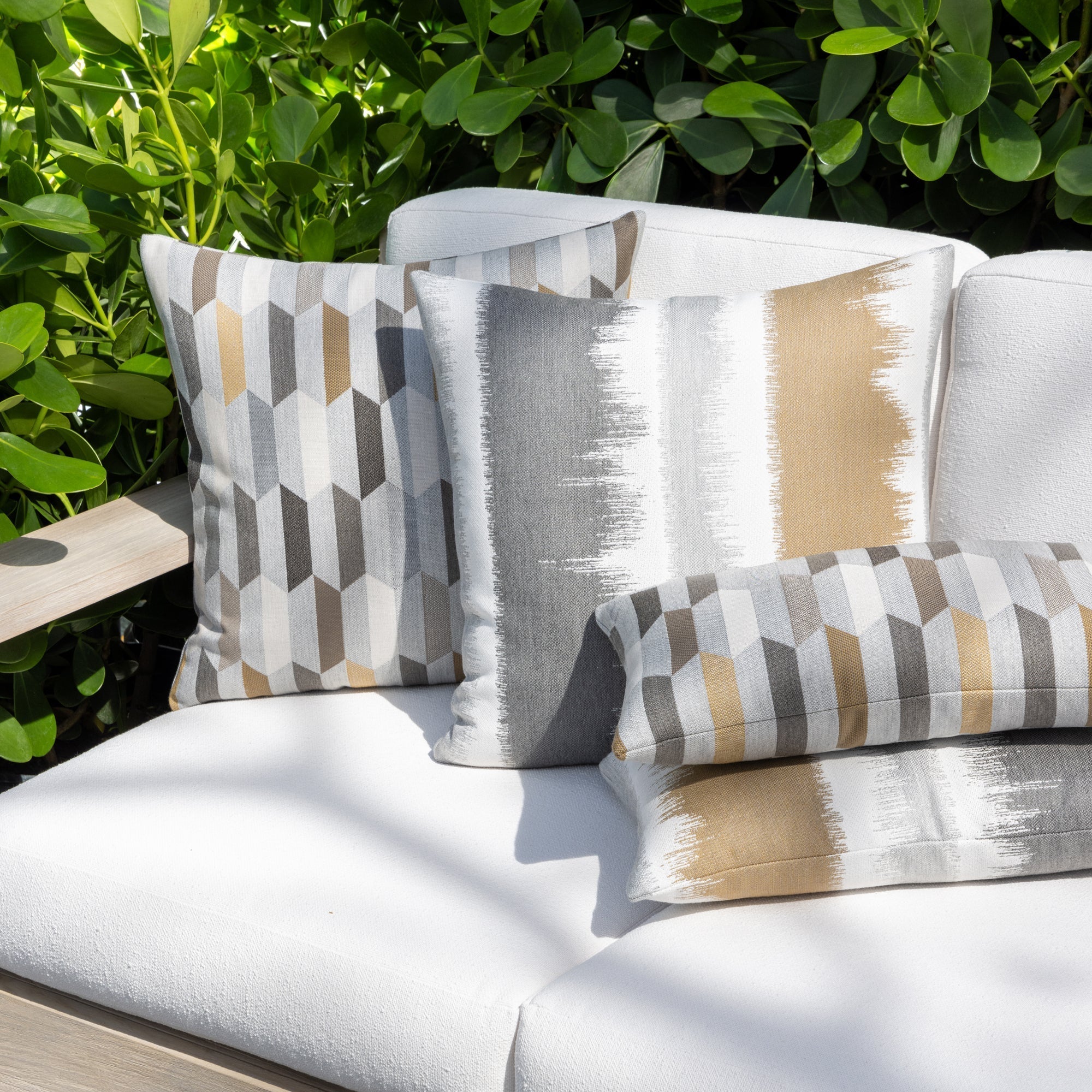 Outdoor image of pillows in Chiseled Camel – outdoor-safe woven fabric by Elaine Smith, ideal for high-end commercial and residential applications.