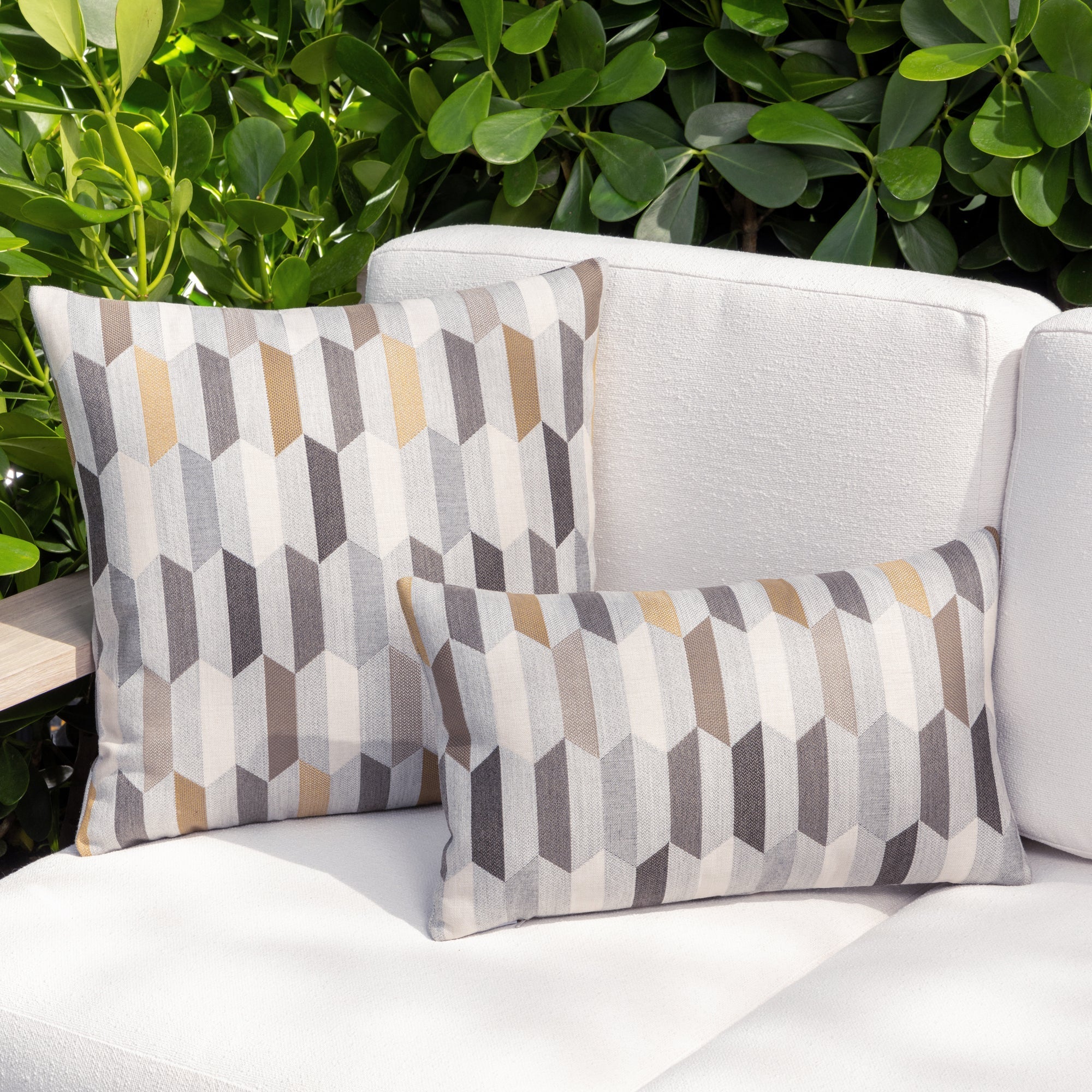 Outdoor image of pillows in Chiseled Camel – outdoor-safe woven fabric by Elaine Smith, ideal for high-end commercial and residential applications.