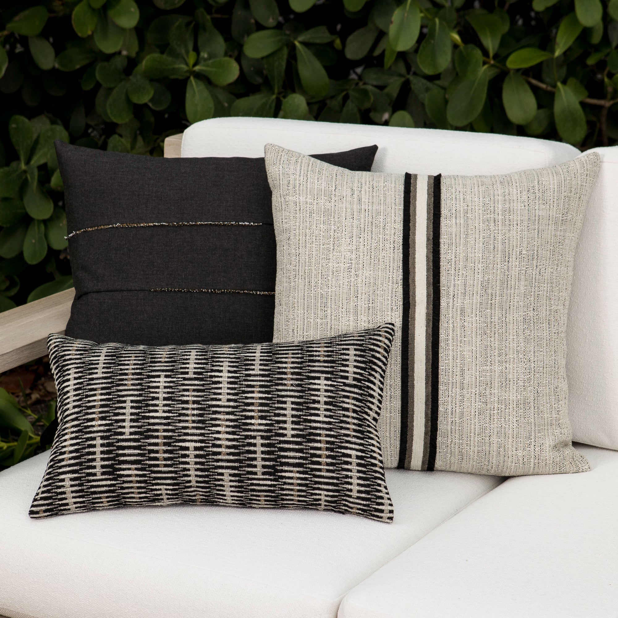 Outdoor image of pillows in Solid carbon black outdoor-safe woven fabric
