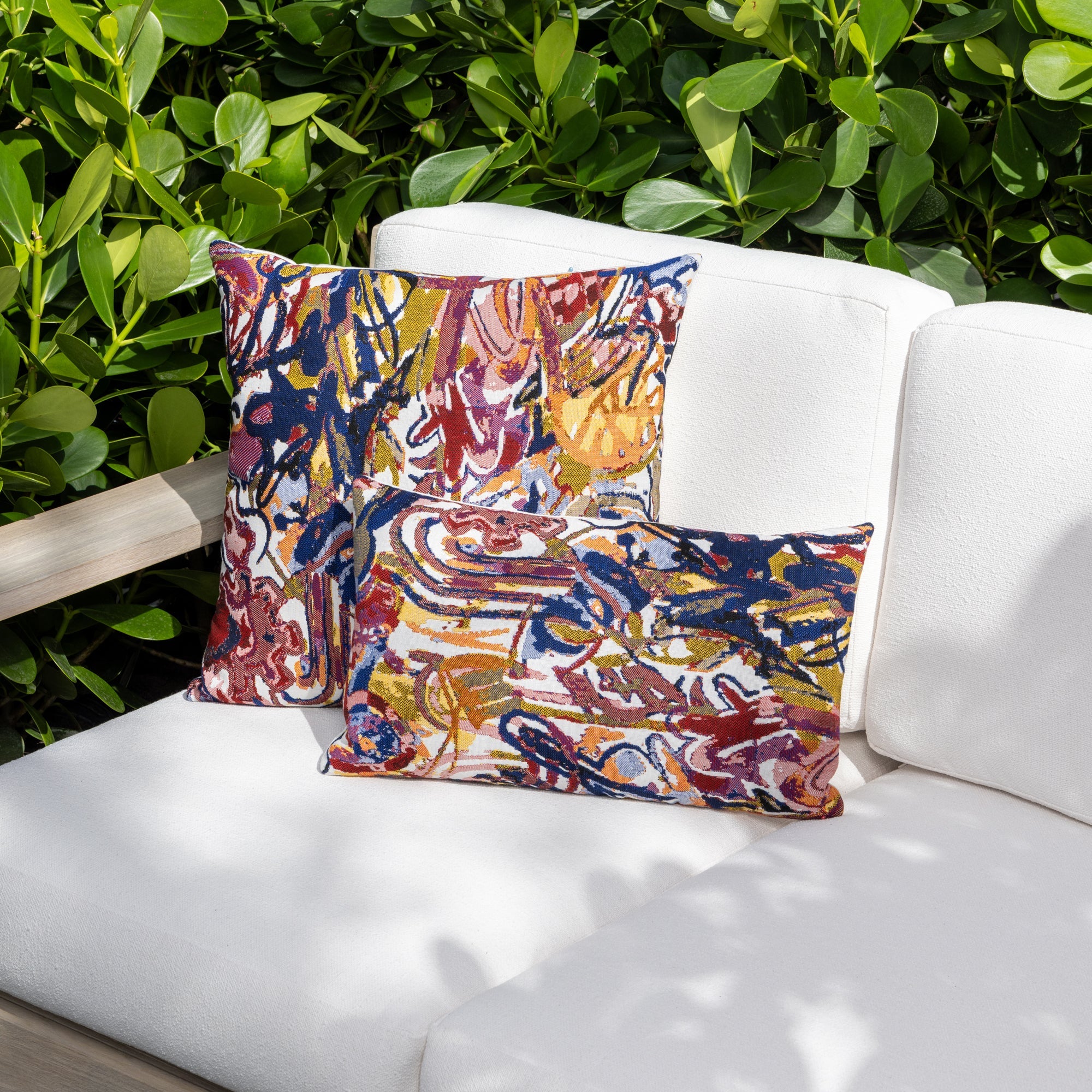 Outdoor image of pillows in Graffiti – outdoor-safe woven fabric by Elaine Smith, ideal for high-end commercial and residential applications.