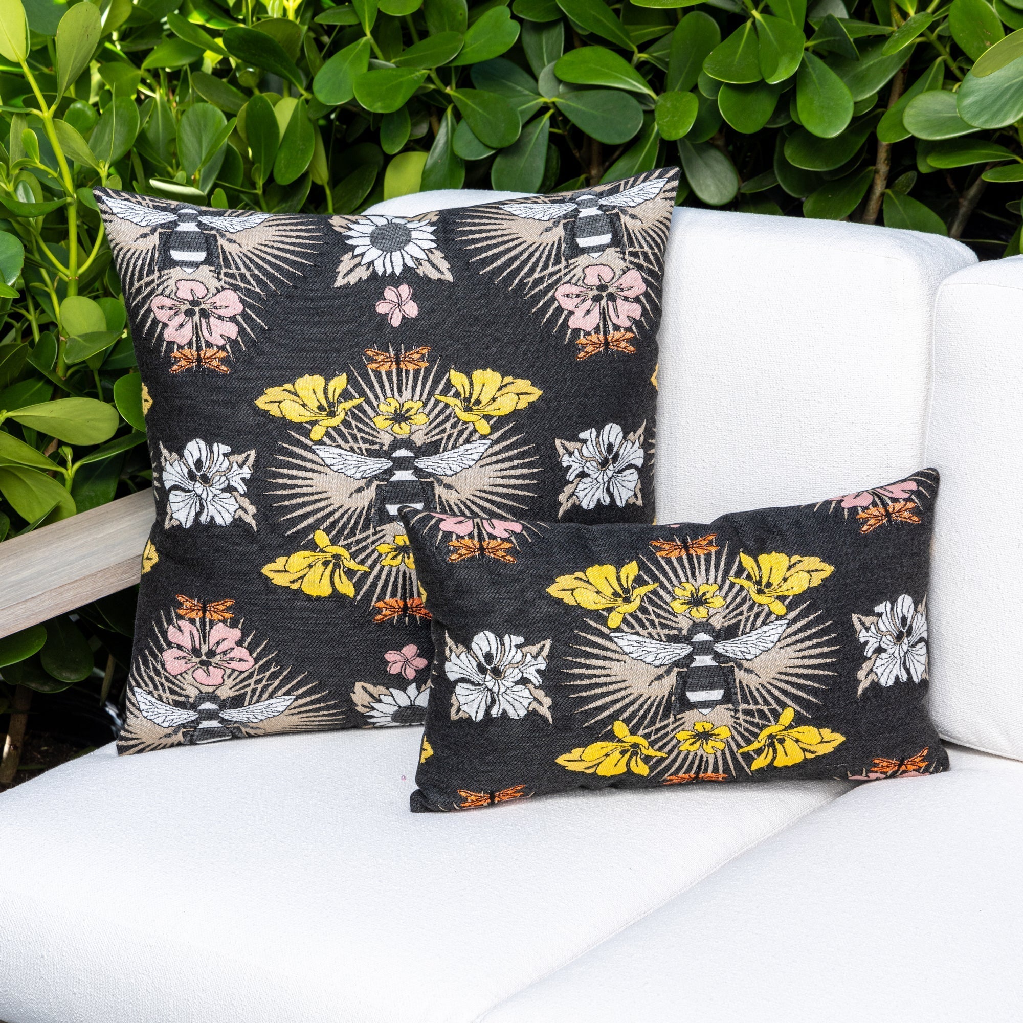 Luxury terracotta tropical leaf patterned square pillow on a rooftop seating area, featuring tailored seams for a polished look to complete indoor and outdoor decor by Elaine Smith