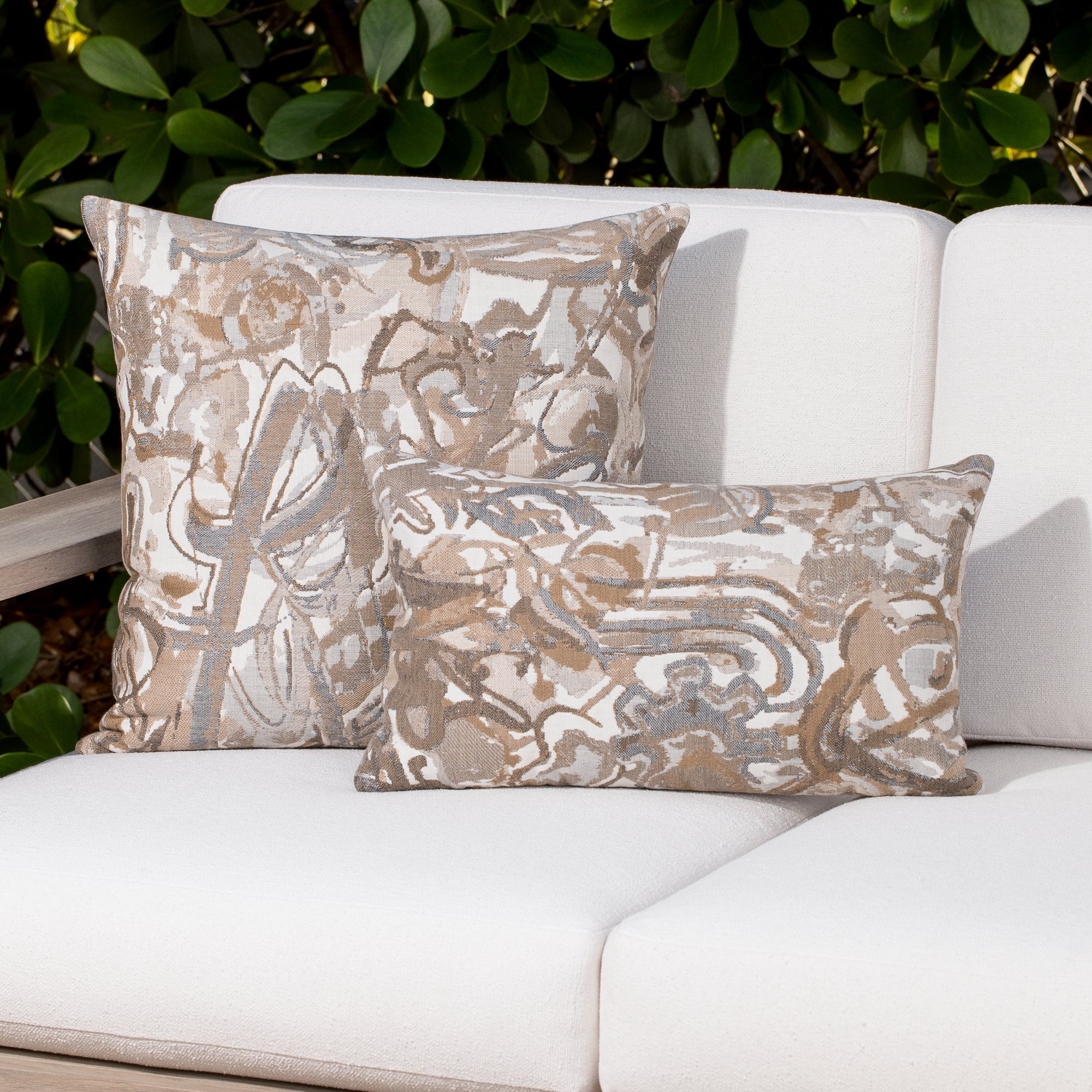 Luxury sand modern patterned accent pillow on a outdoor sofa styled for hospitality suites, featuring weather resistant performance fabric for indoor and outdoor use by Elaine Smith