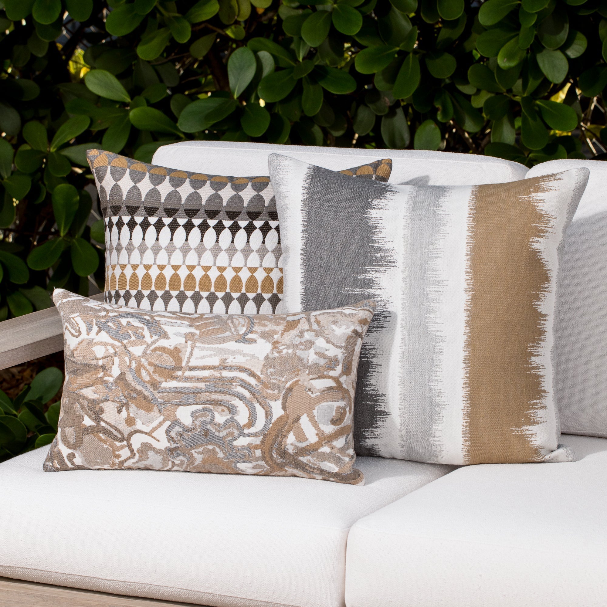 Luxury sand modern patterned accent pillow on a outdoor sofa styled for hospitality suites, featuring weather resistant performance fabric for indoor and outdoor use by Elaine Smith