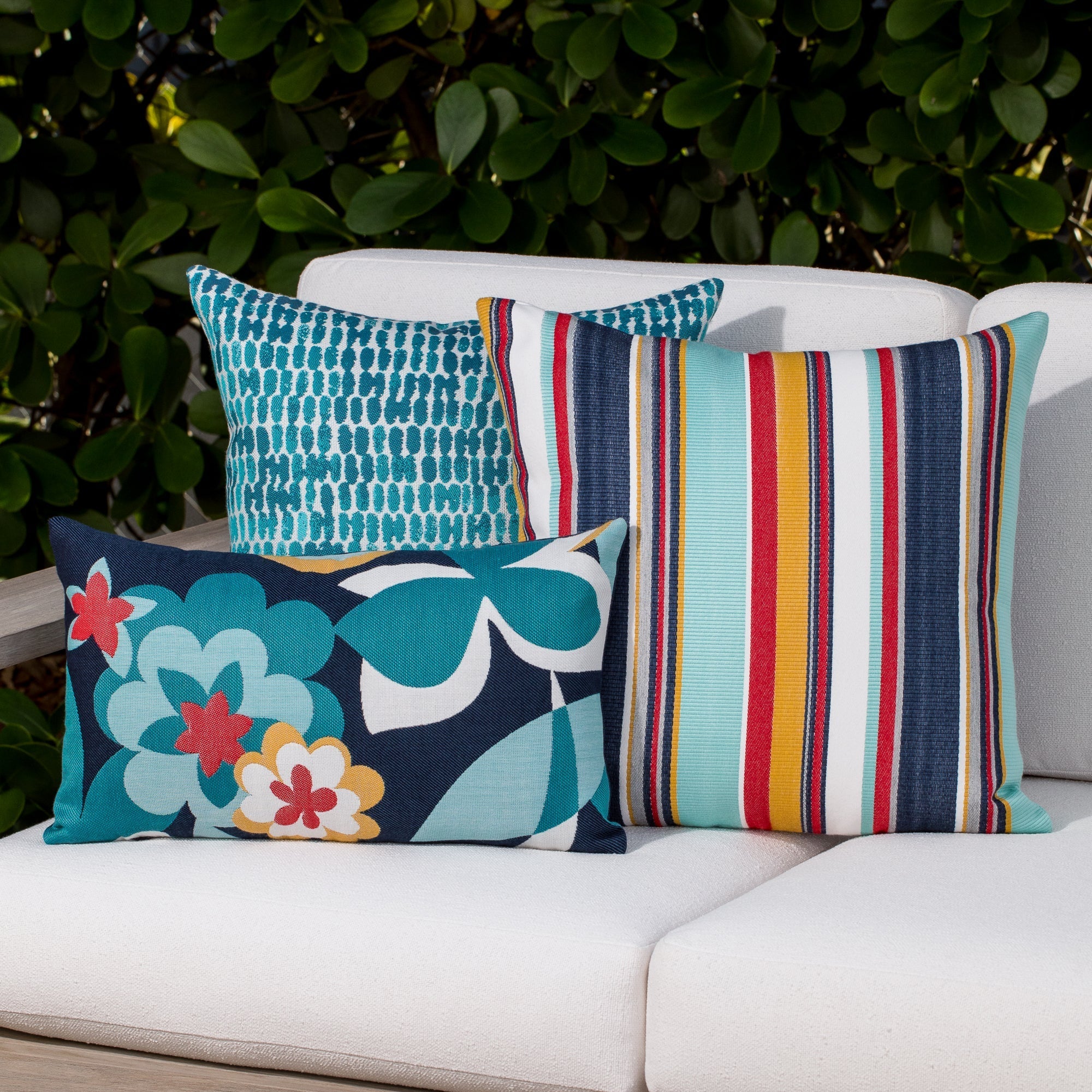 Luxury blue and white textured woven decorative pillow on a outdoor sofa, featuring tailored seams for a polished look to complete indoor and outdoor decor by Elaine Smith