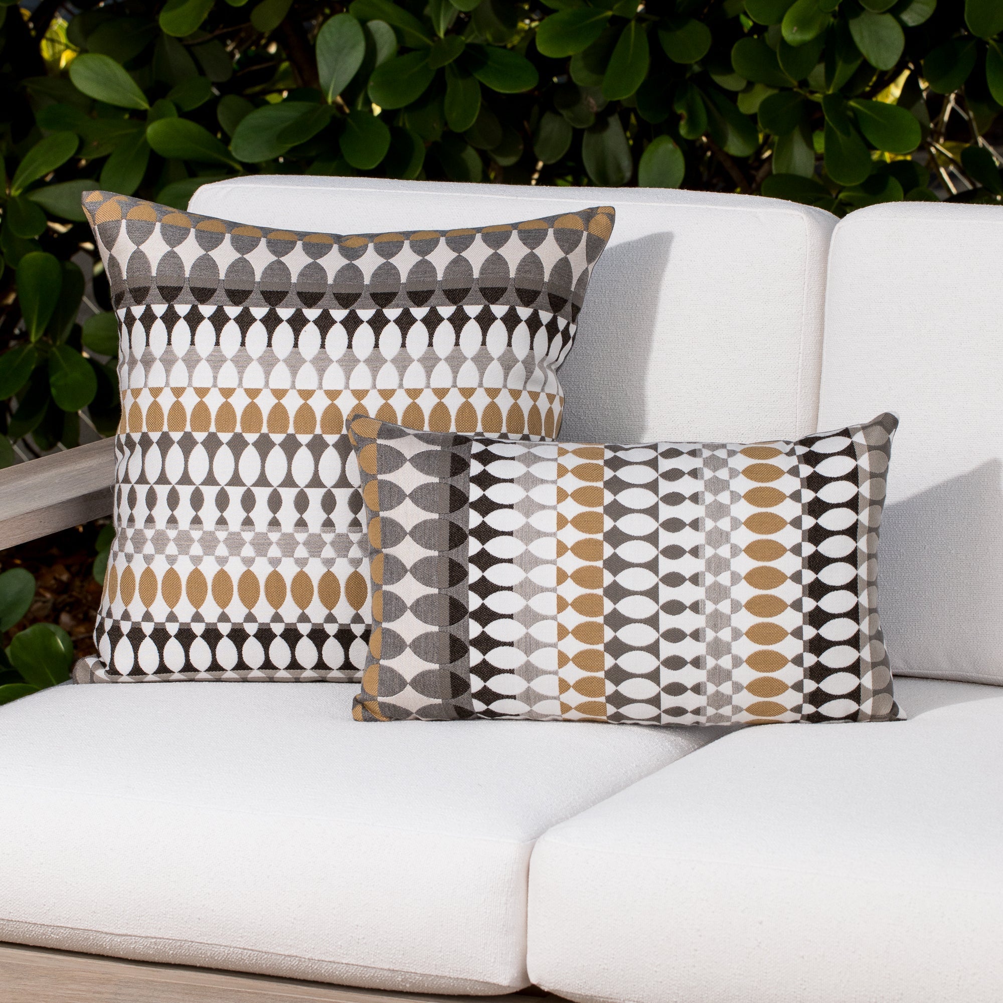 Luxury soft gray striped decorative pillow on a outdoor sofa, featuring all weather performance construction for residential and commercial interiors