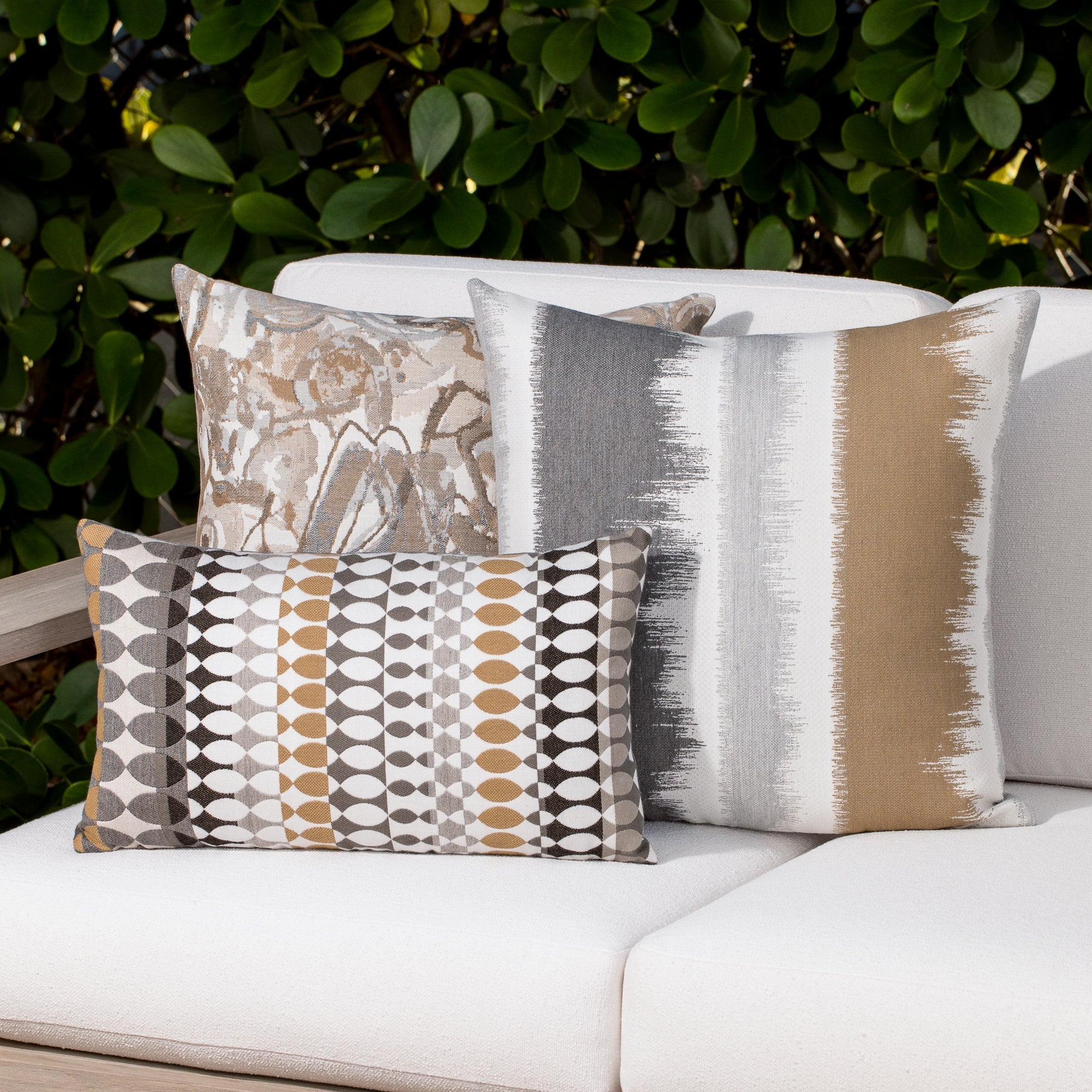 Luxury soft gray striped decorative pillow on a outdoor sofa, featuring all weather performance construction for residential and commercial interiors
