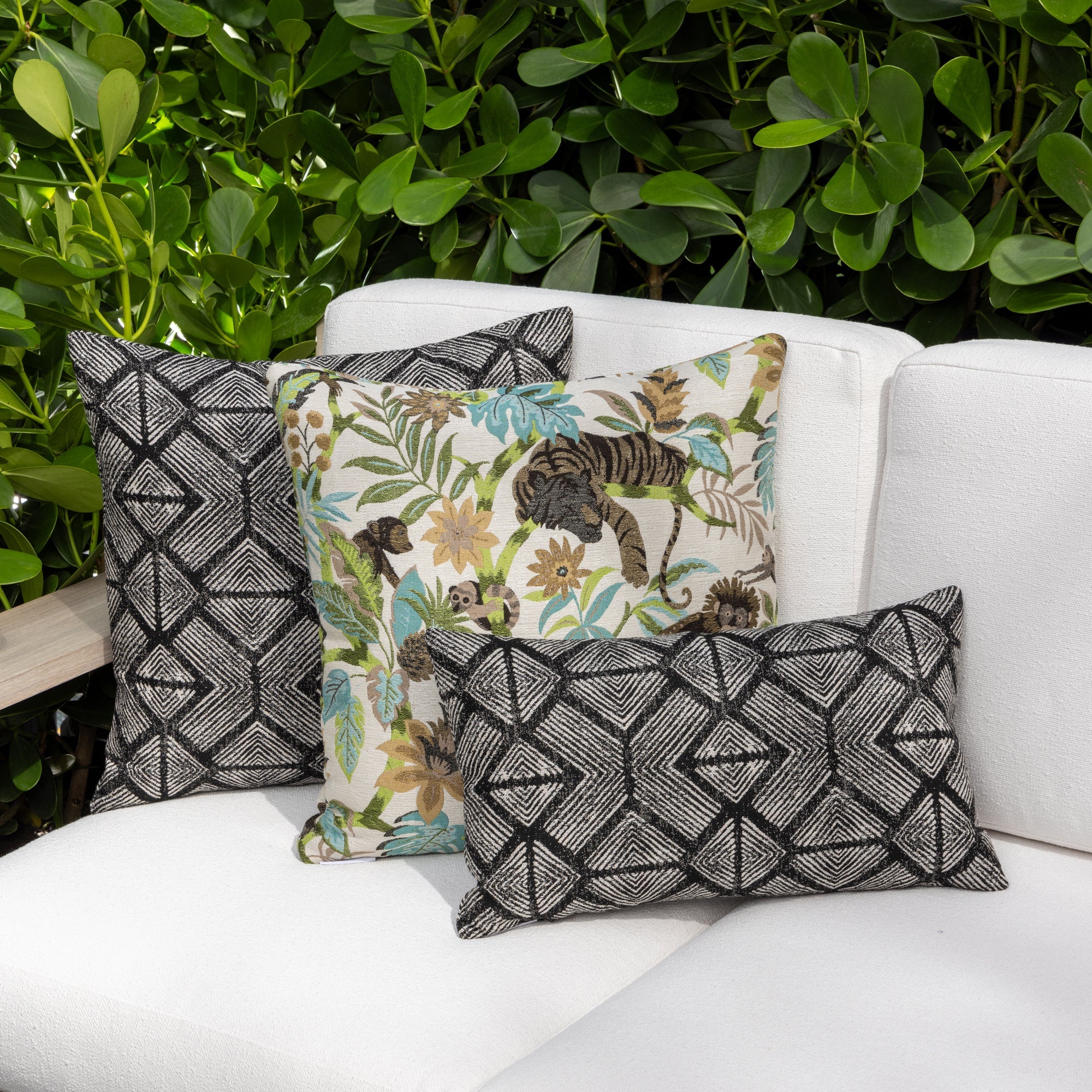 Outdoor image of pillows in Tribal-inspired geometric outdoor safe fabric in ebony tones